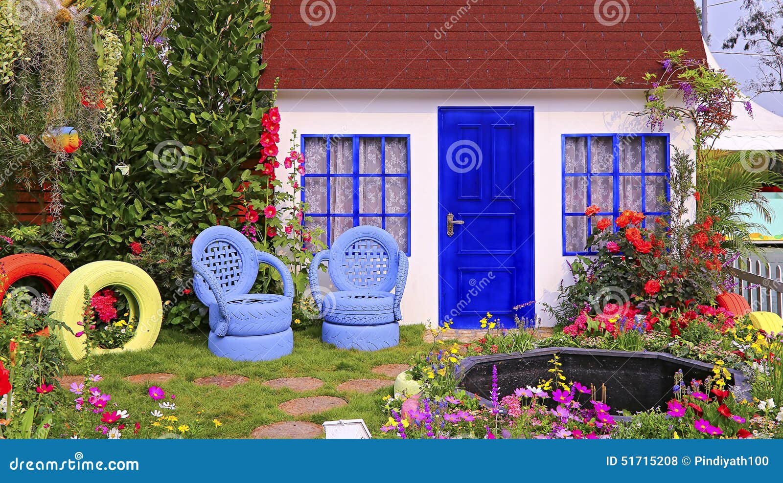 spring garden wooden house autumn foliage artistic chairs made rubber tires small pond well 51715208