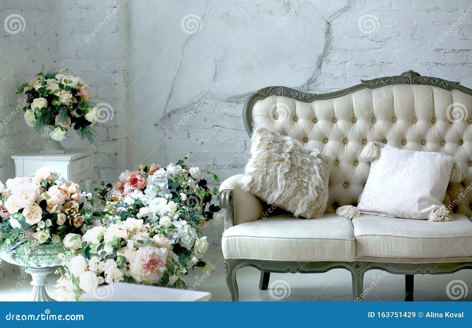Spring Interior in Studio with Flowers and a Classic Sofa Stock Image