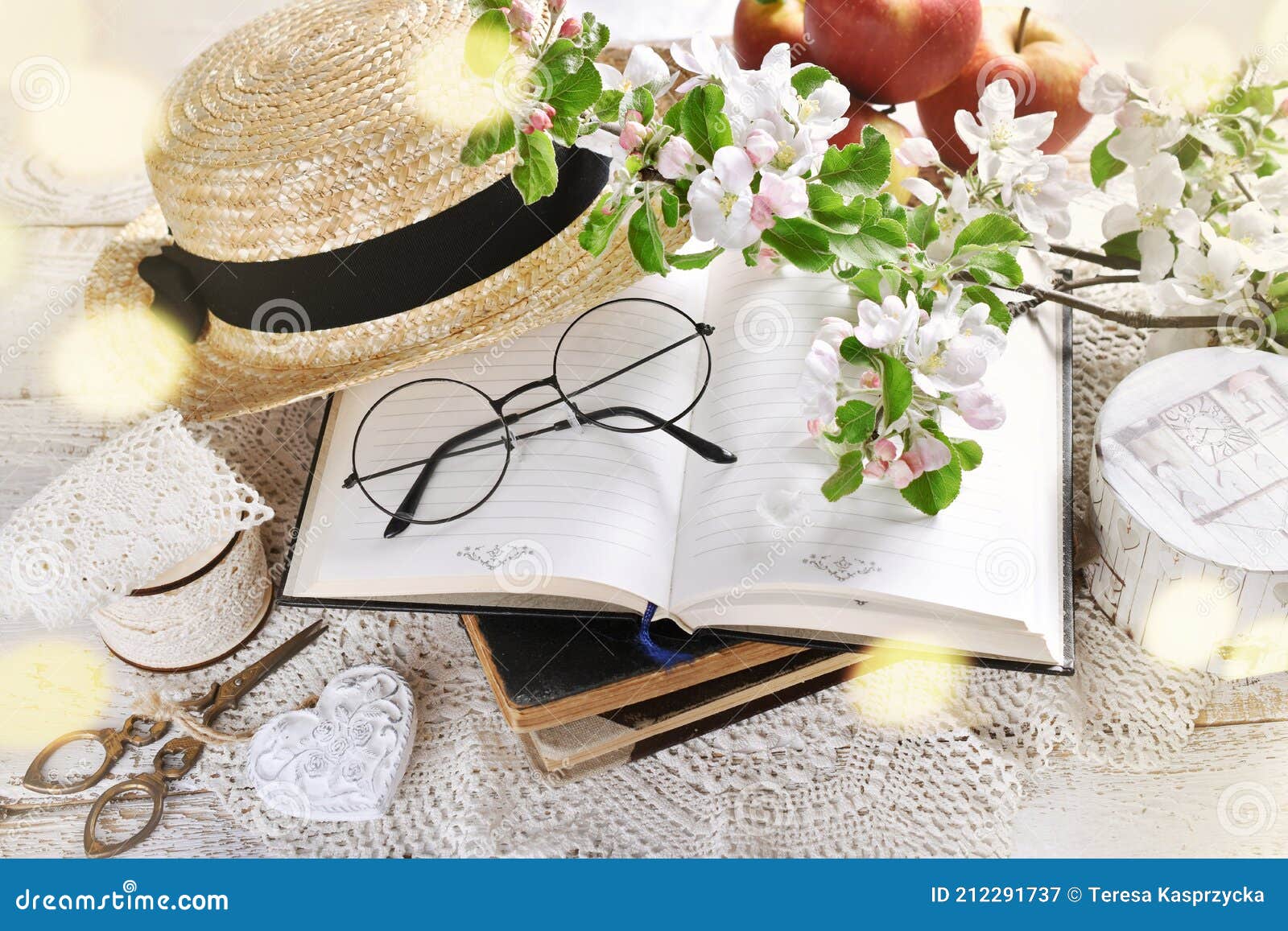 spring still life in romantic style with apple blossoms on old books