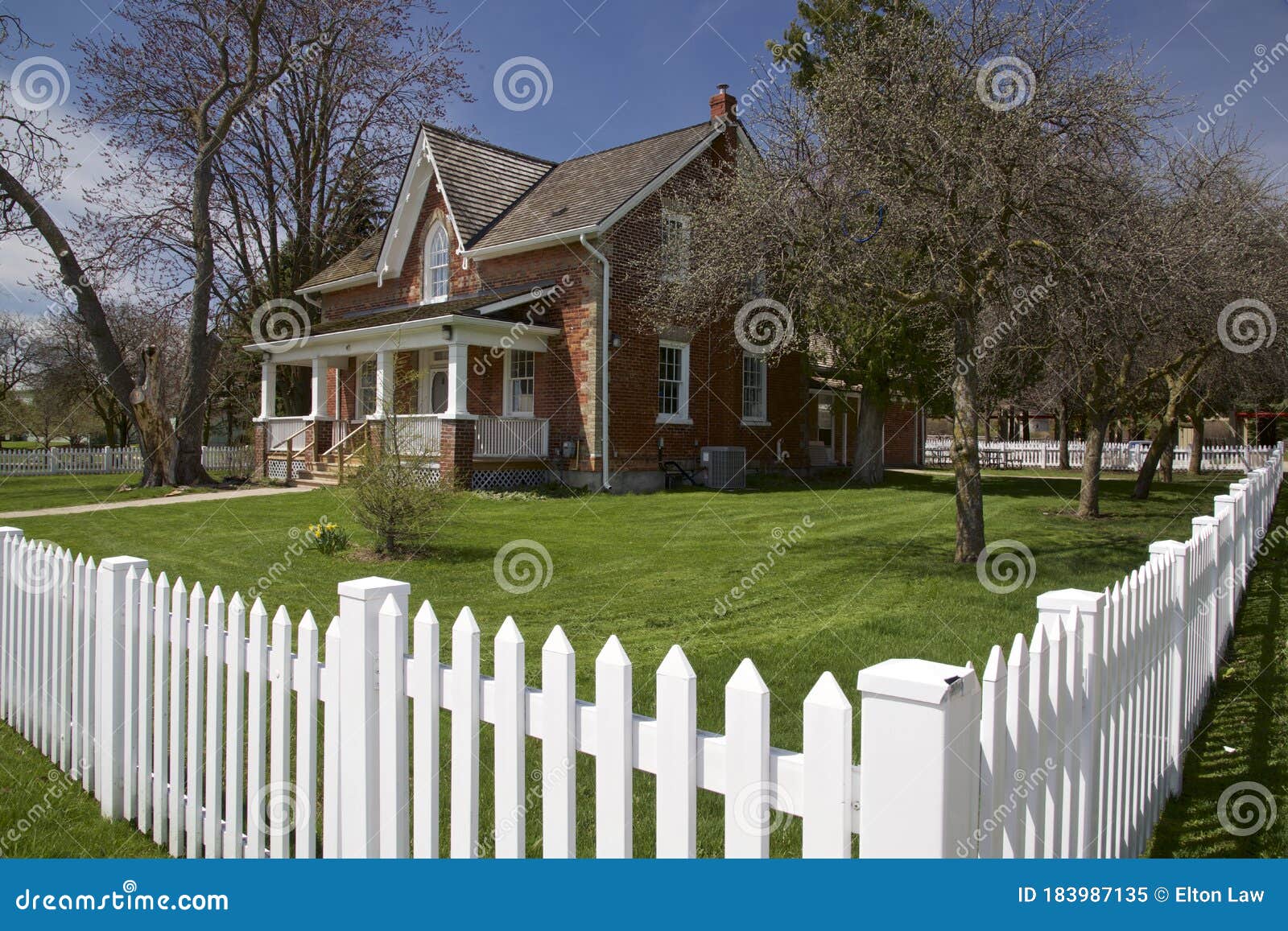 Springtime in the Front Lawn of the House with White Picket Fences Stock Image