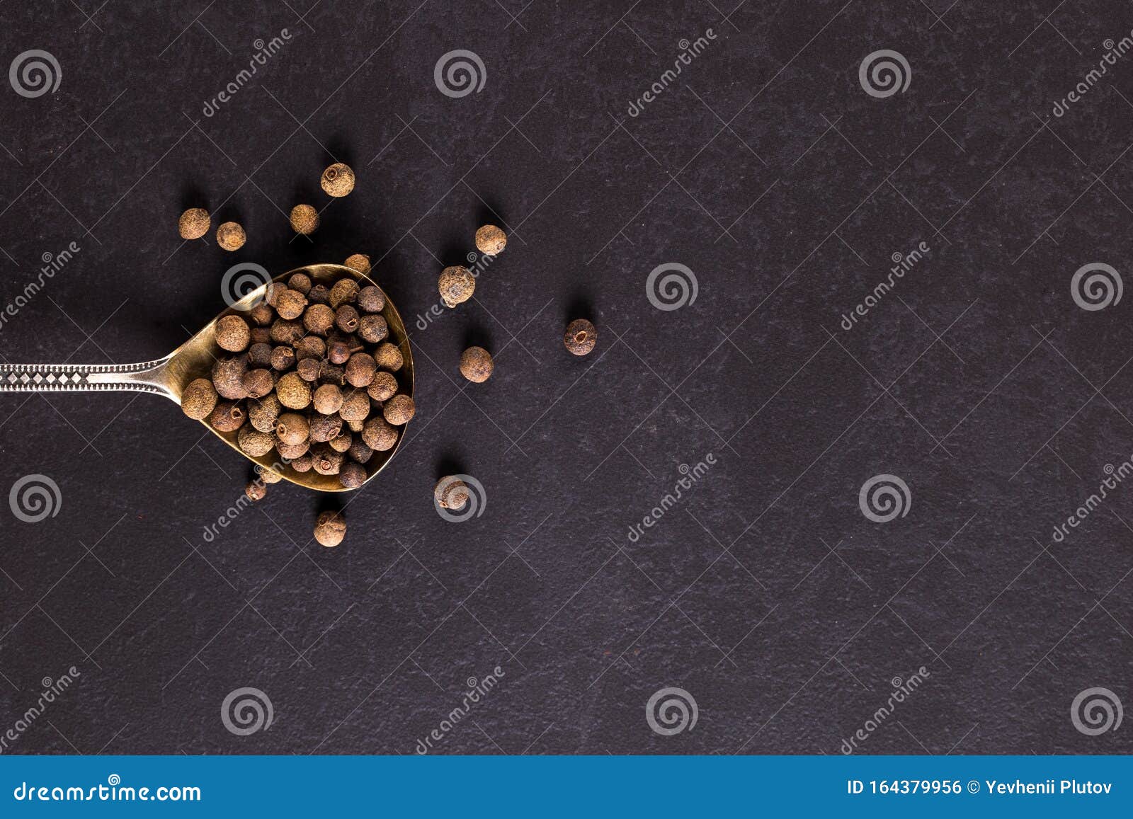 Sprinkled Black Pepper in an Iron Spoon. Concept, Copy Space Stock