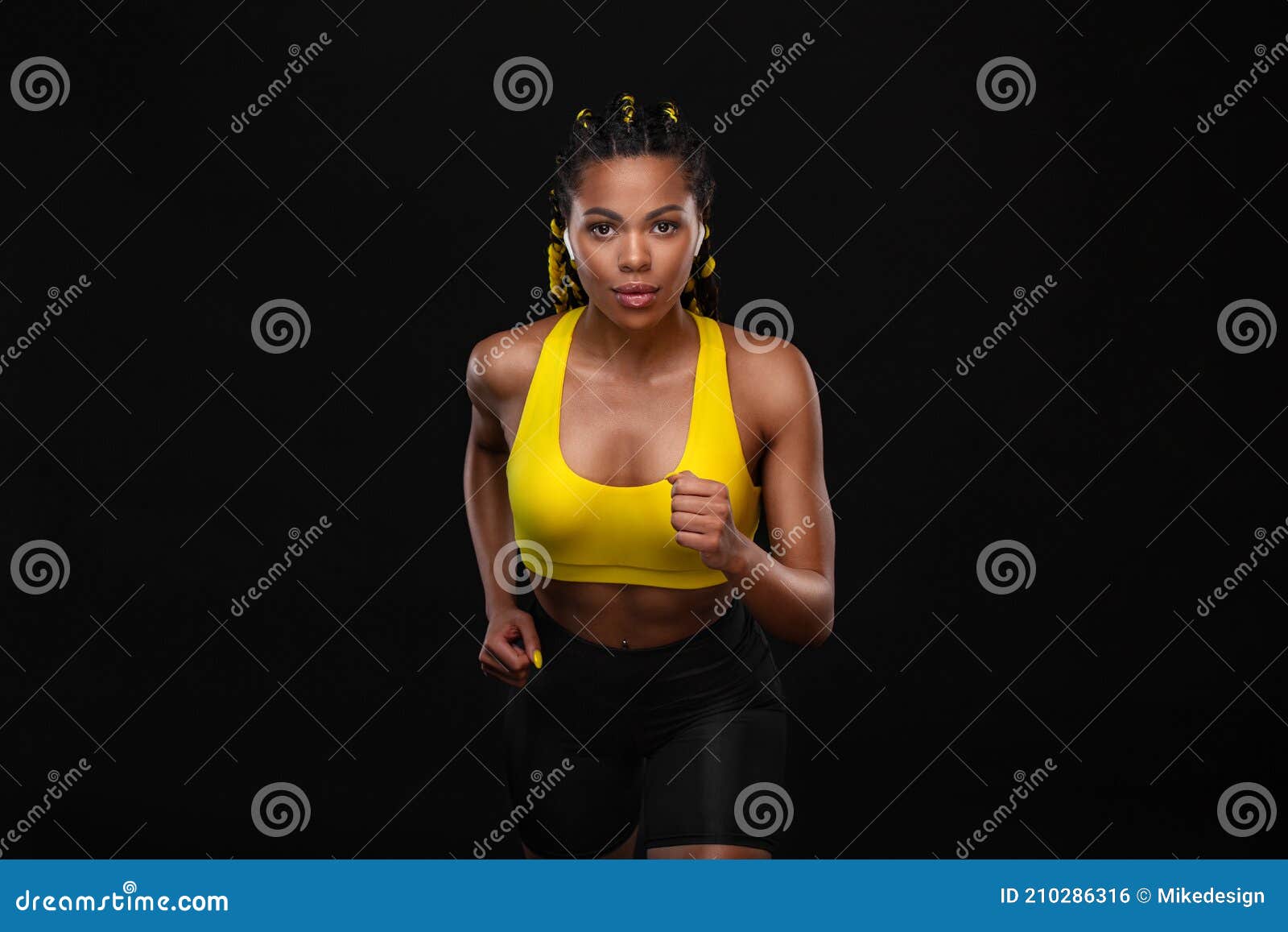 Sprinter Run. Strong Athletic Woman Running on Black Background
