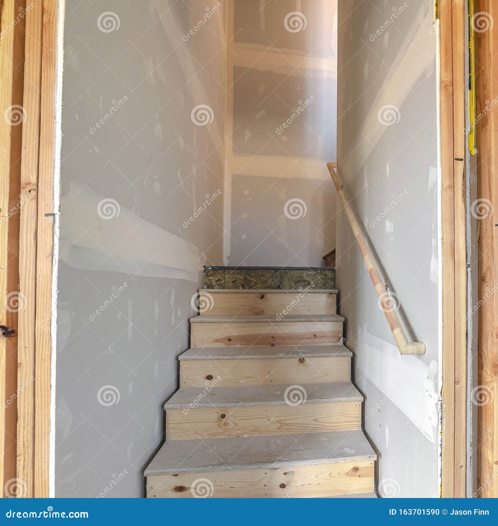 Square Under Construction Wooden Stairs In A Basement Stock Photo