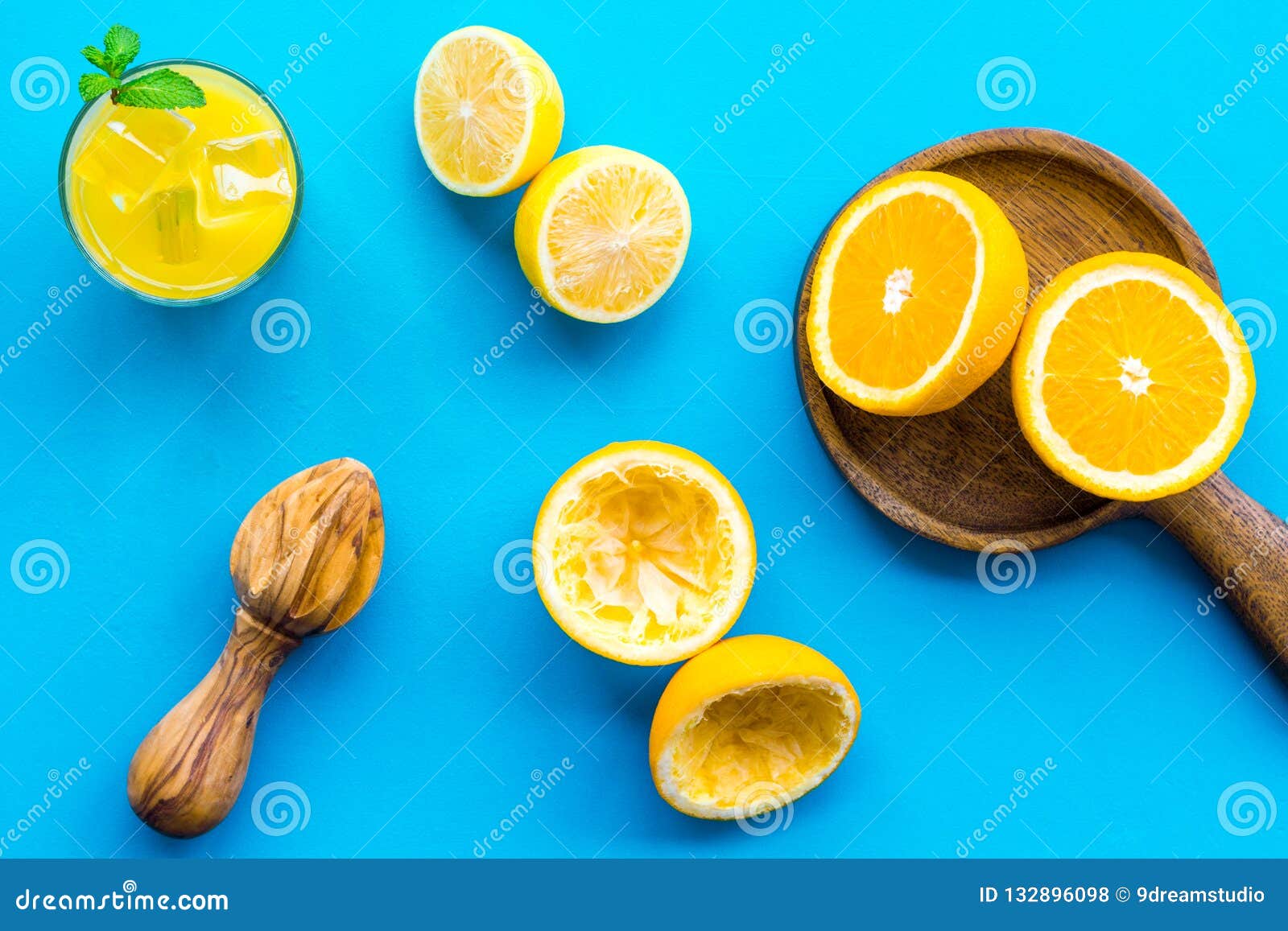 Squeeze Fresh Oranges With Juicer. Orange Juice In Glass Near Half Cut Oranges On Blue ...