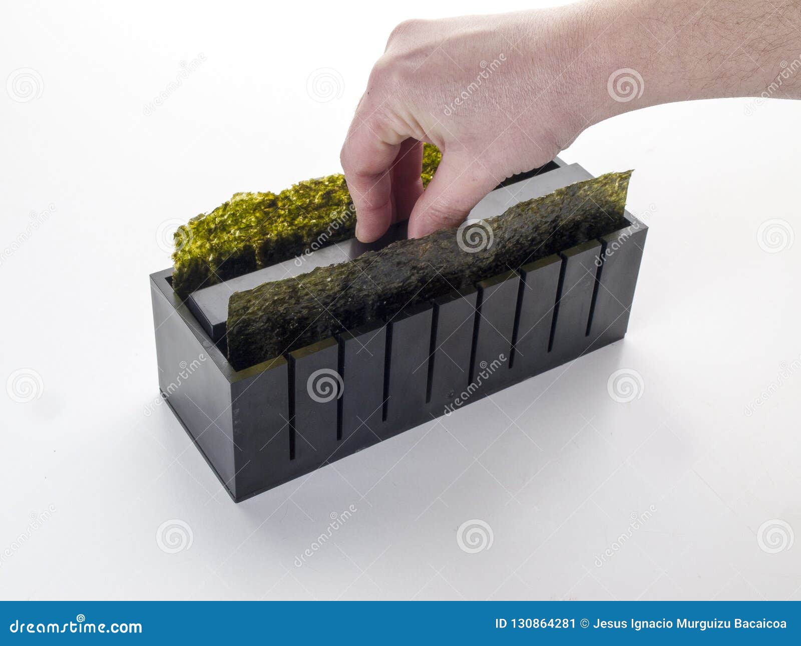 squeezing the sushi rice inside a cutting mold