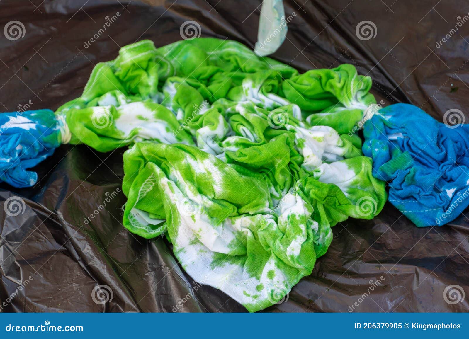squished green and blue tie dye shirt with wet dye for children`s creative and artistic 