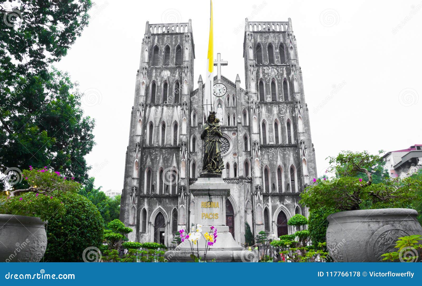 st. joseph`s cathedral and regina pacis queen of peace statue in front, hanoi, vietnam. st. joseph`s cathedral is a neogothic