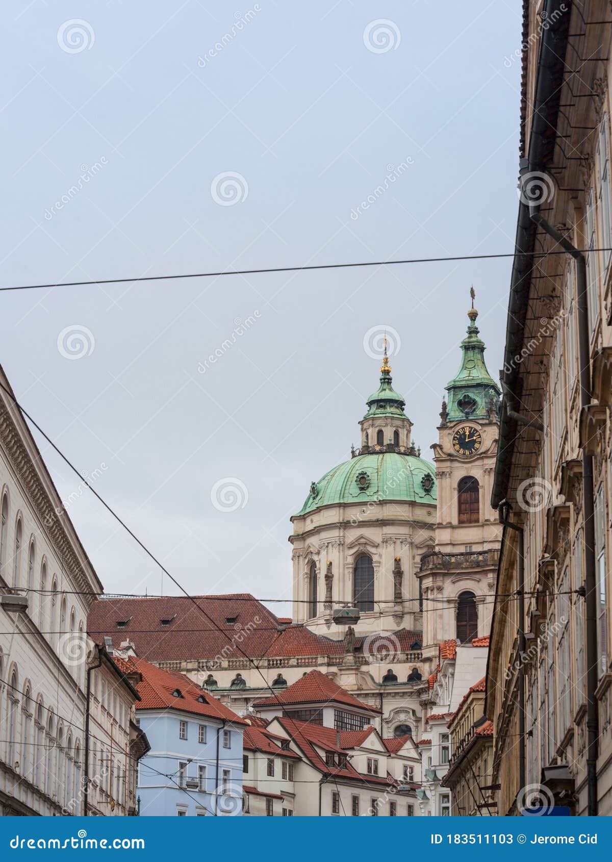 st nicholas church, also called kostel svateho mikulase, in prague, czech republic, with its iconic dome seen from nearby streets