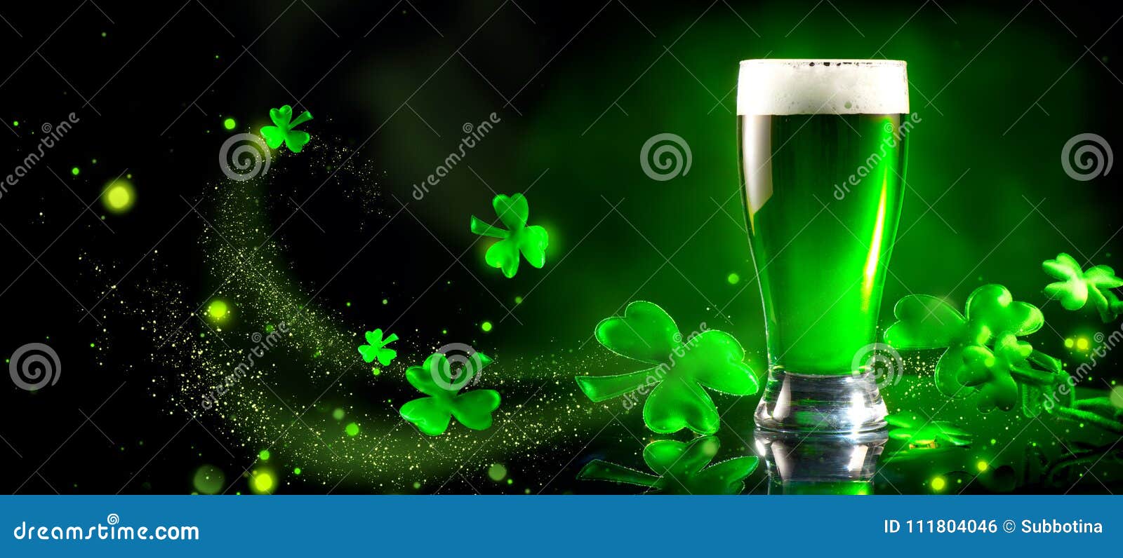 st. patrick`s day. green beer pint over dark green background, decorated with shamrock leaves