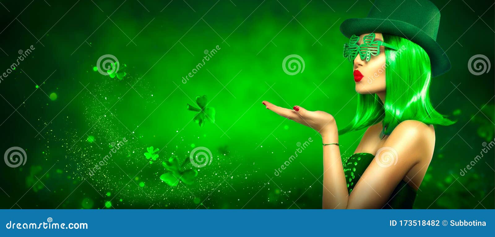 st. patrick`s day leprechaun laughing model girl pointing hand, holding product on green magic background