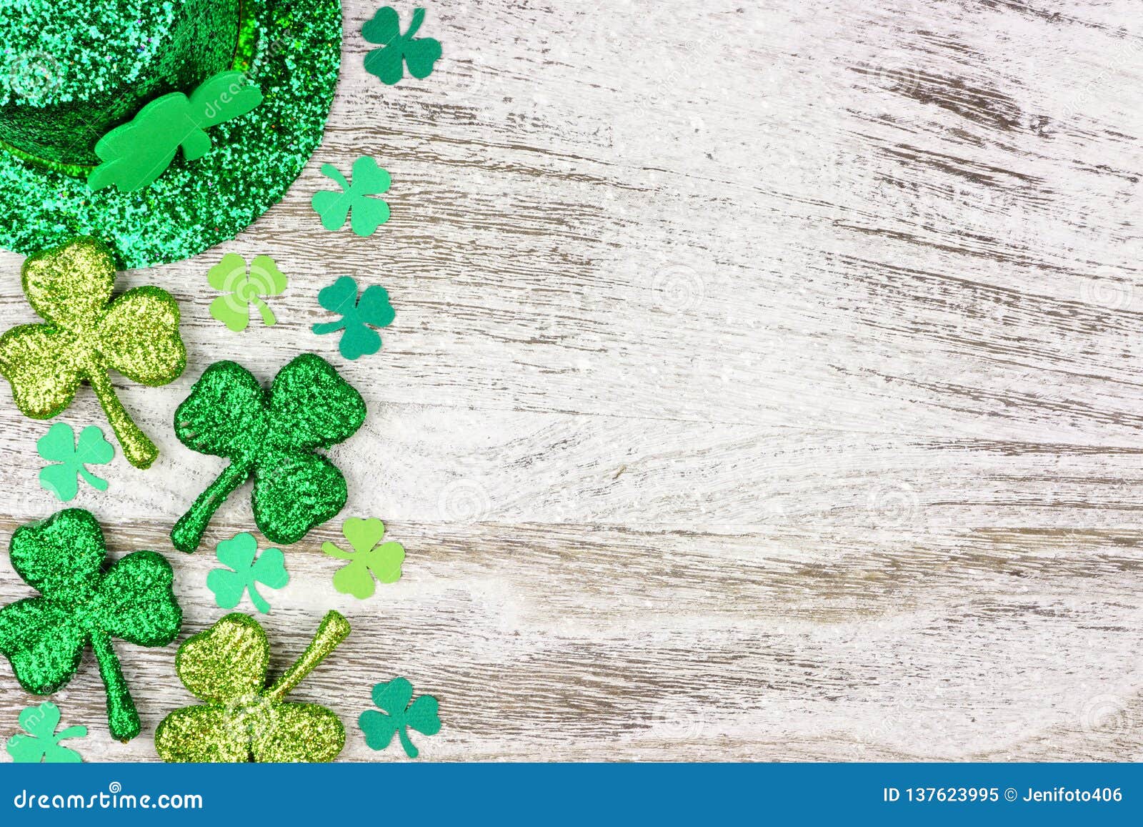 st patricks day side border of shamrocks, leprechaun hat over white wood