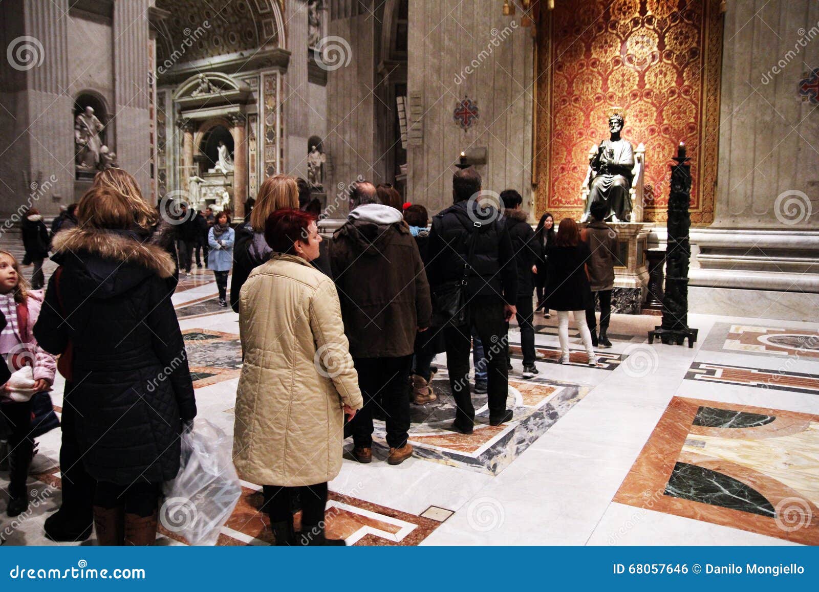 St. peter line. The line of believers in front of the holy statue of st. peter inside his basilica at rome in italy