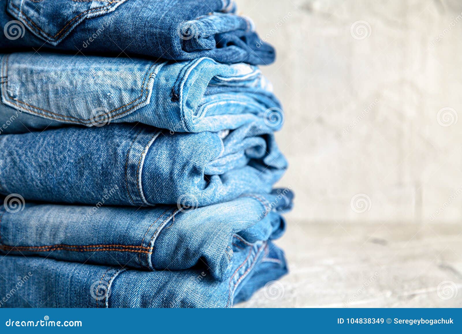 Stack of Blue Jeans on a Gray Background Stock Image - Image of blue ...