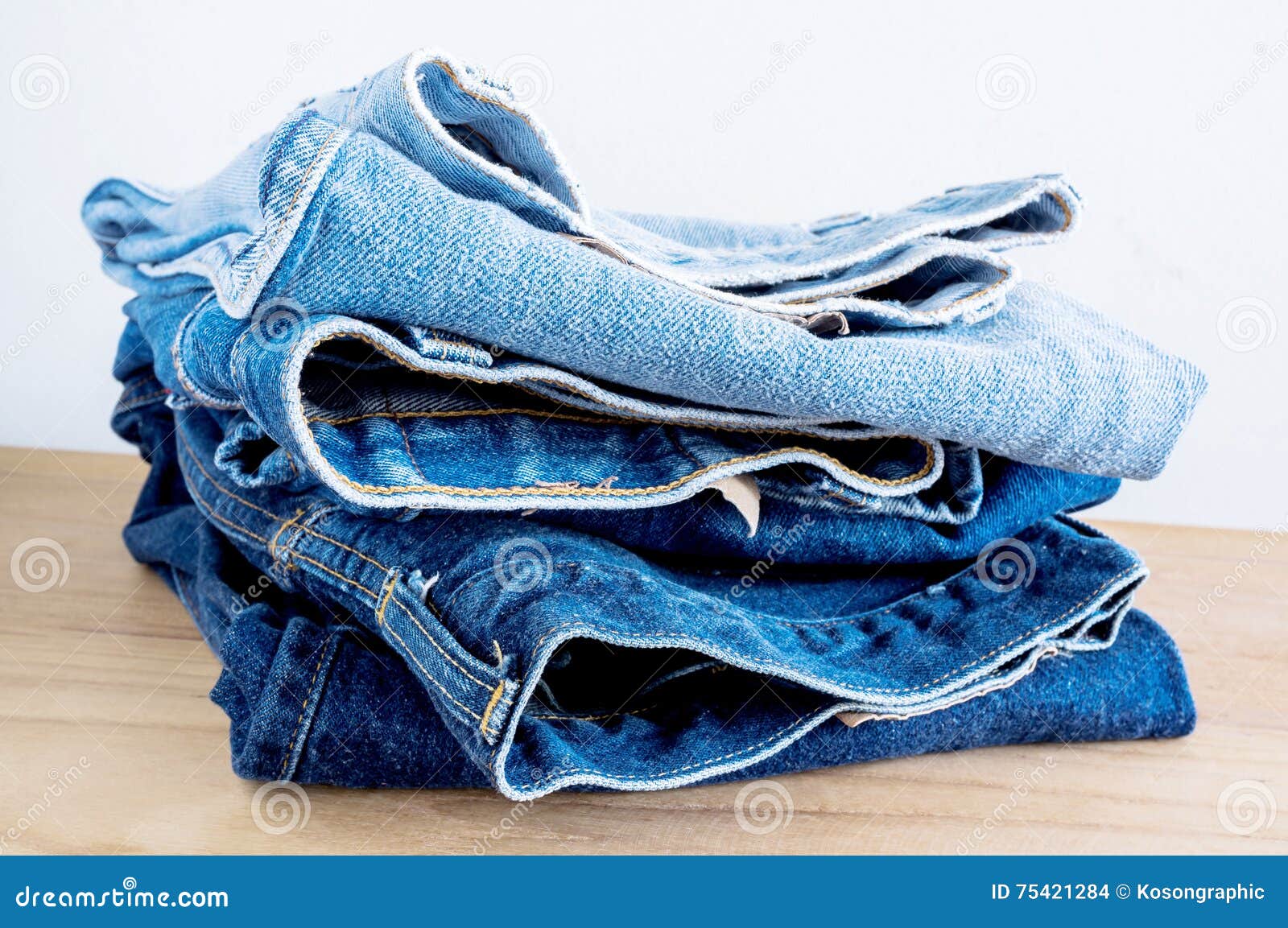 Stack of Blue Jeans on Wooden Table. Stock Photo Image of group