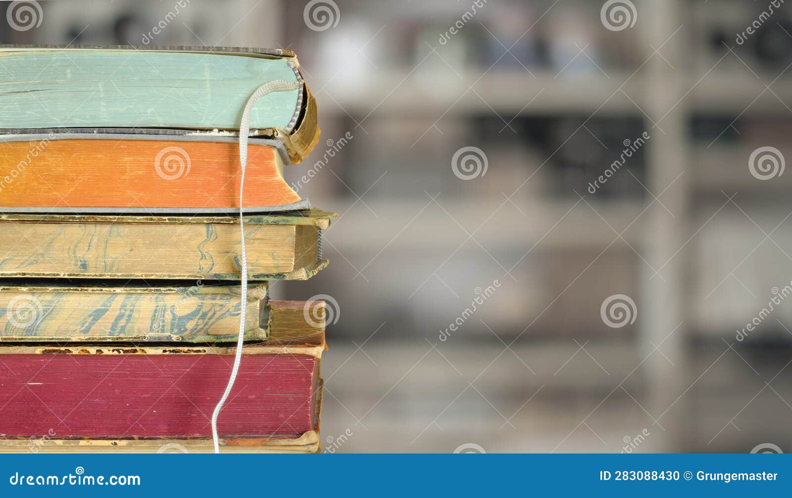 Stack of Books with Blurred Bookshelf Background, Reading, Learning