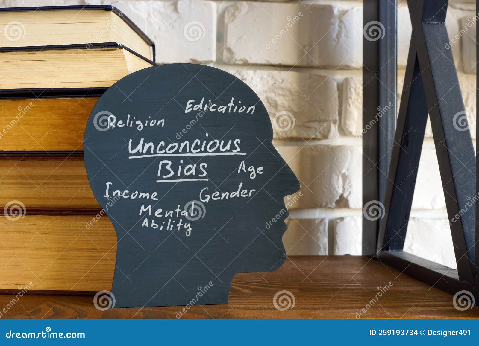 a stack of books and a head with an inscription unconscious bias.