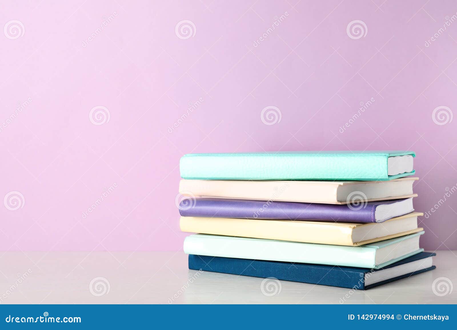 Stack of Books on Shelf Against Color Background Stock Photo Image of