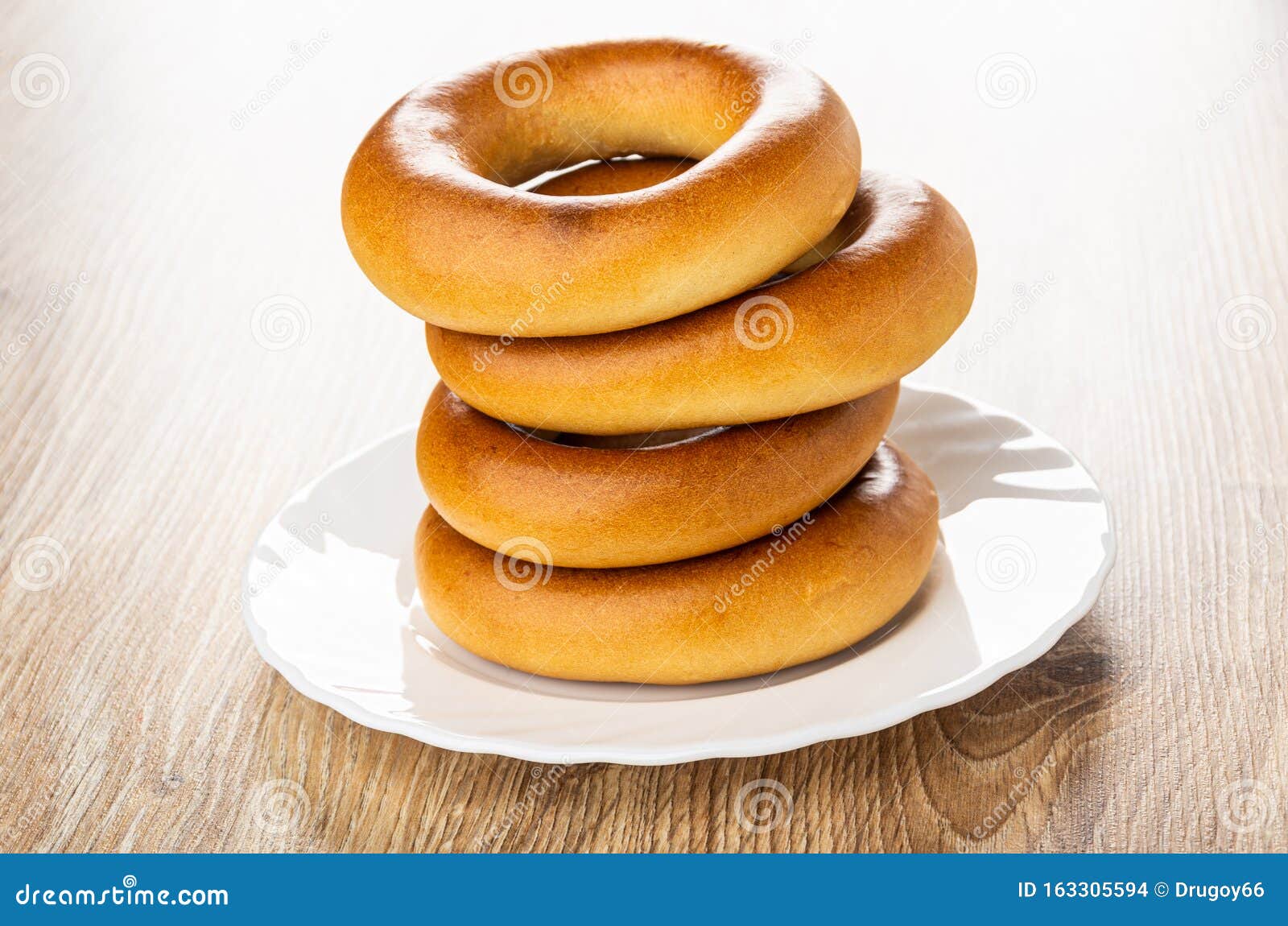 stack of bread rings baranka in plate  on wooden table