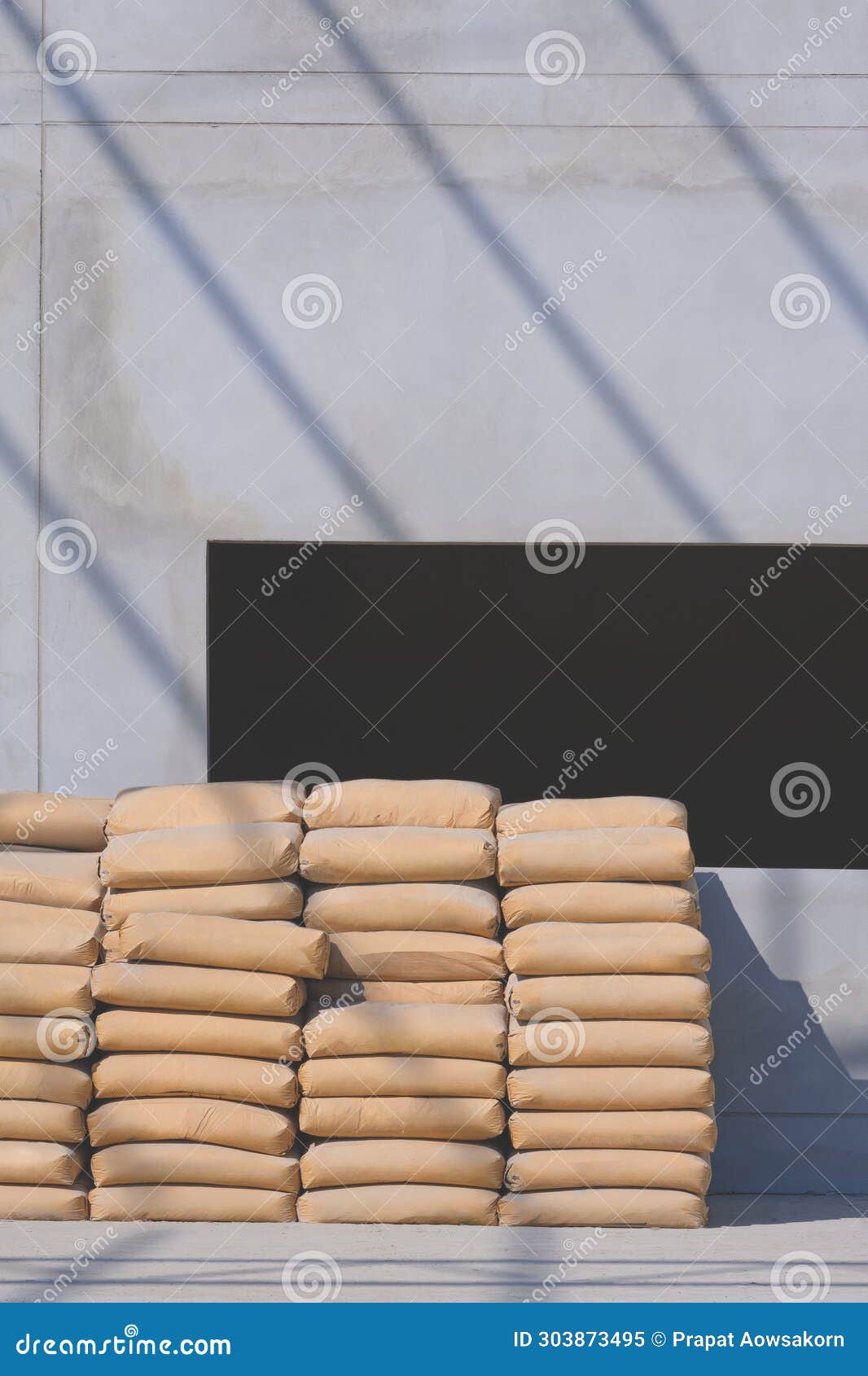 Stack of Cement Sacks on the Floor in Front of Window Frame on Concrete