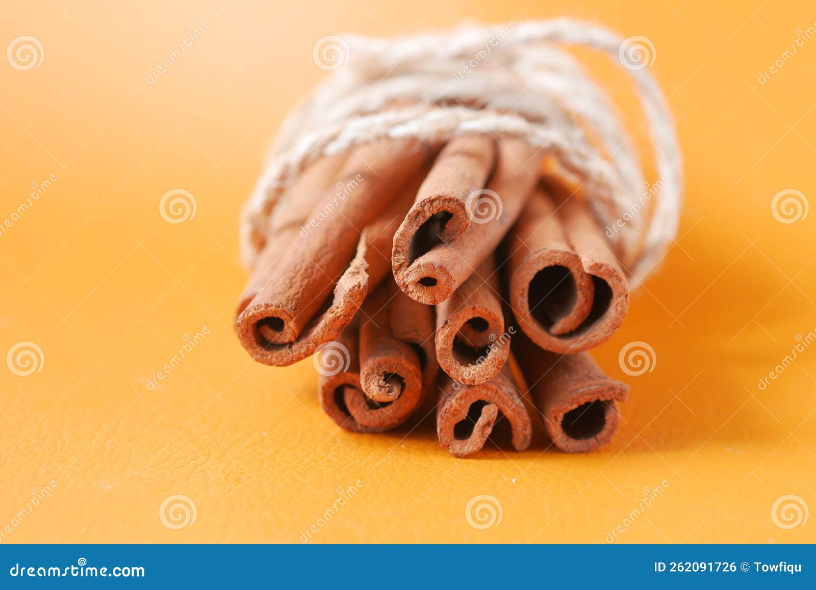 Stack of Cinnamon Sticks on Orange Background Stock Photo Image of