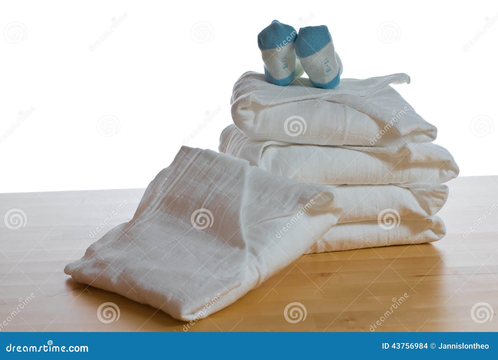 Stack of Classical Square White Cloth Diapers with Blue Socks Stock
