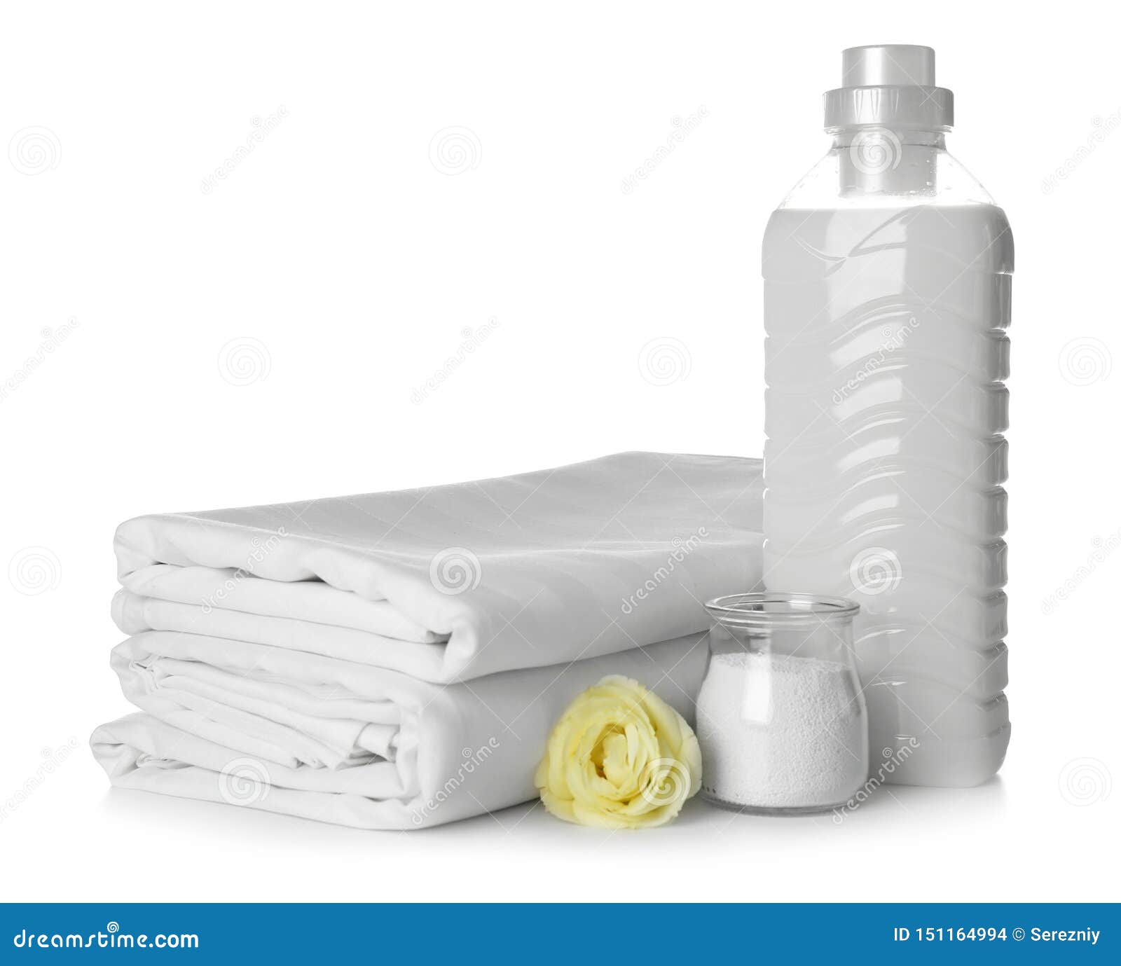 Stack of Clean Bed Sheets and Washing Detergents on White Background