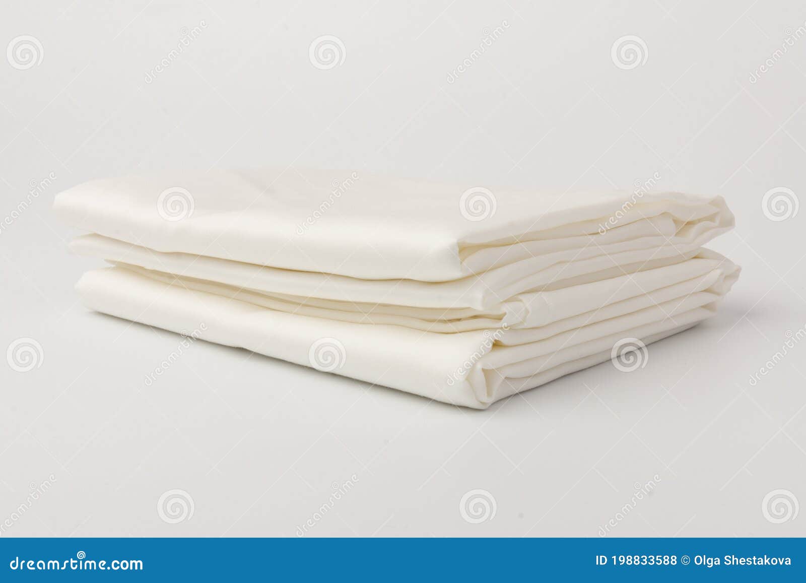Stack of Clean Bed Sheets on White Background, Closeup Stock Photo