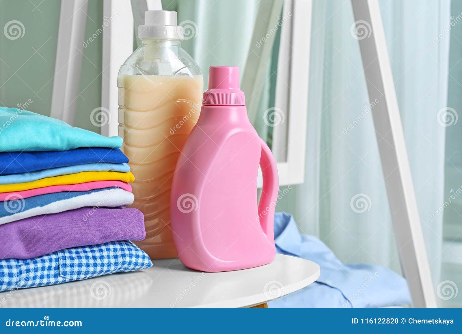 Stack of Clean Clothes and Bottles with Detergent Stock Photo Image