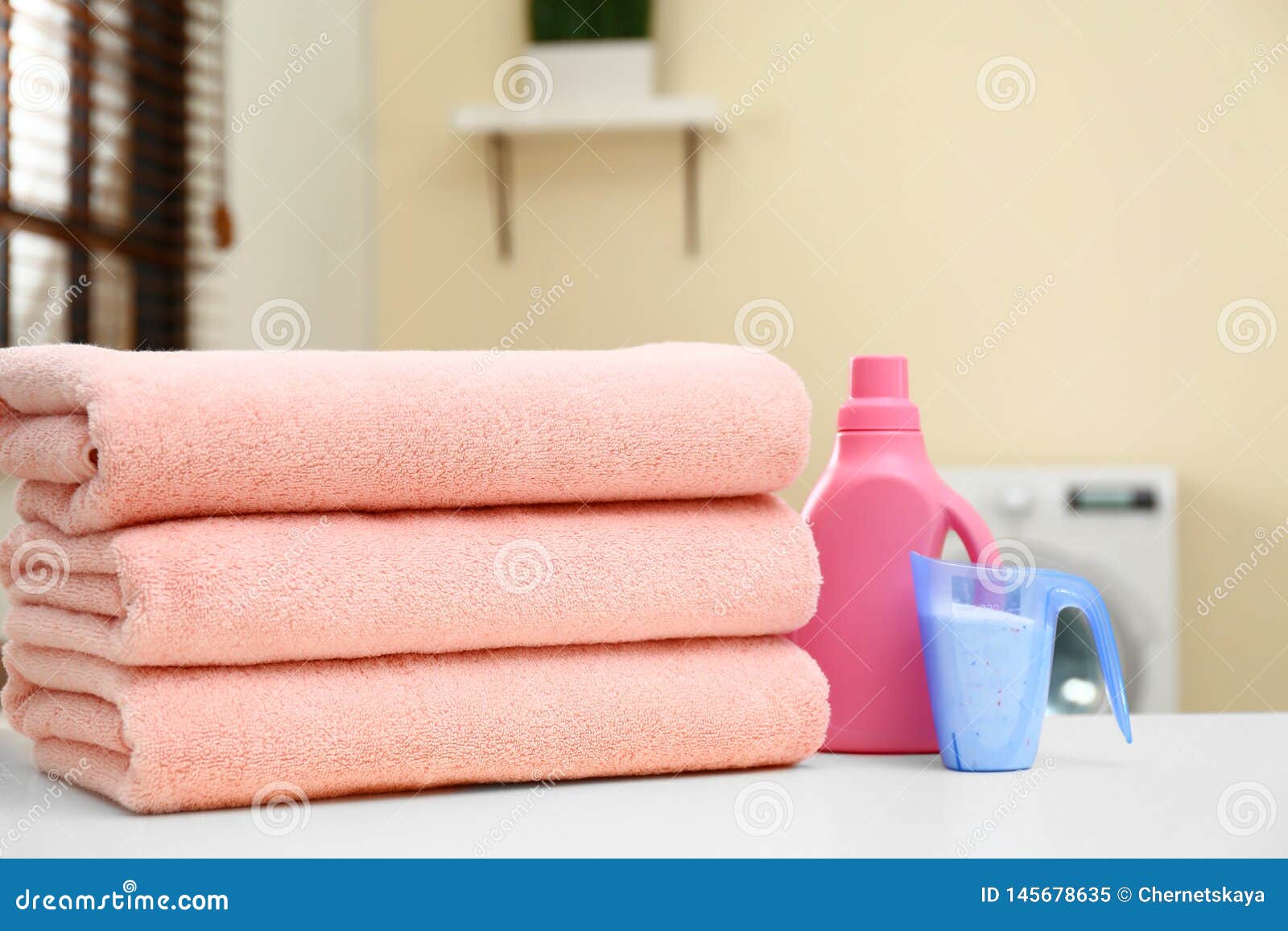 Stack of Clean Towels and Detergents in Laundry Room Stock Image