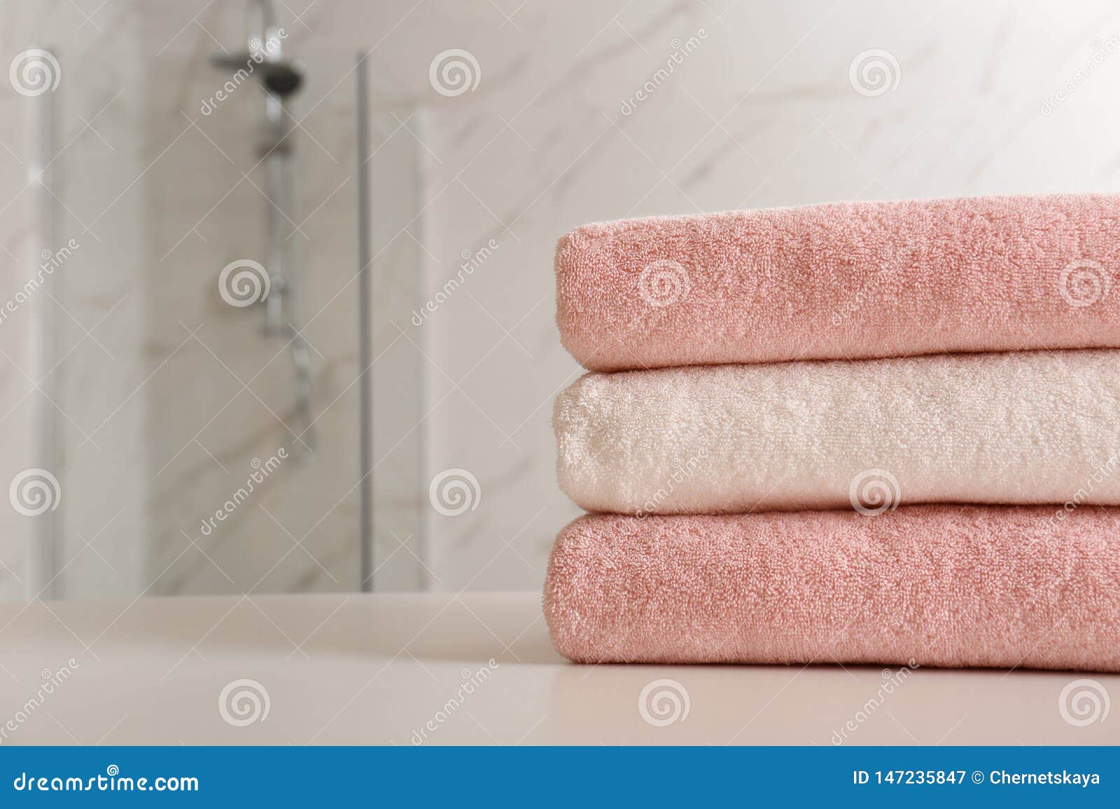 Stack of Clean Towels on Table in Bathroom, Closeup. Stock Image