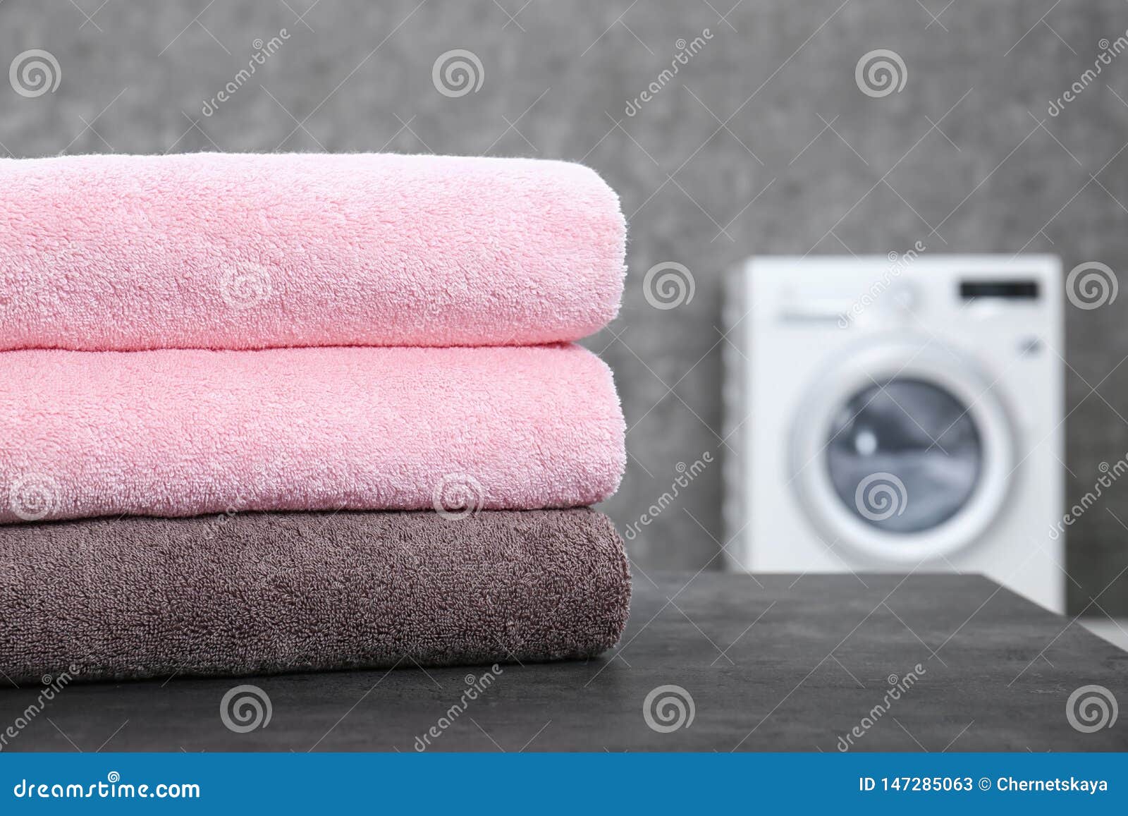 Stack of Clean Towels on Table in Laundry Room, Closeup Stock Image