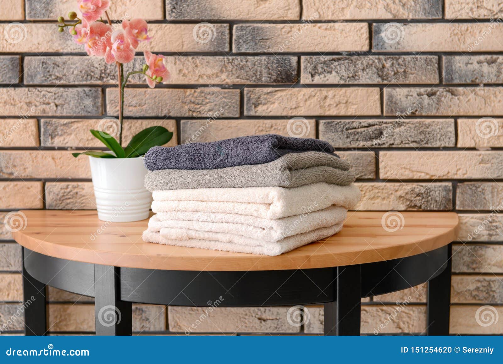 Stack of Clean Towels on Table Near Brick Wall Stock Photo Image of