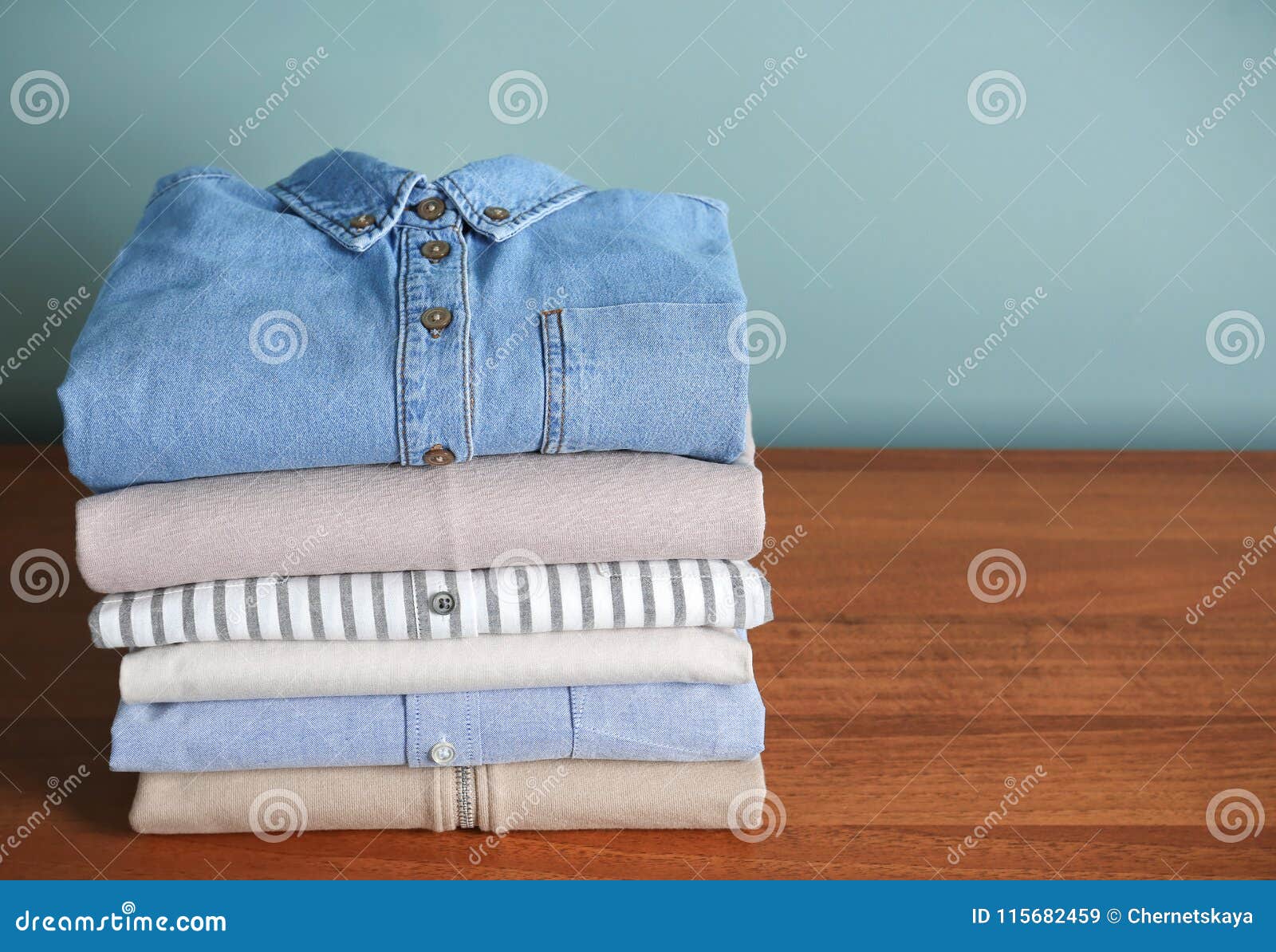 Stack of clothes on table stock image. Image of background - 115682459