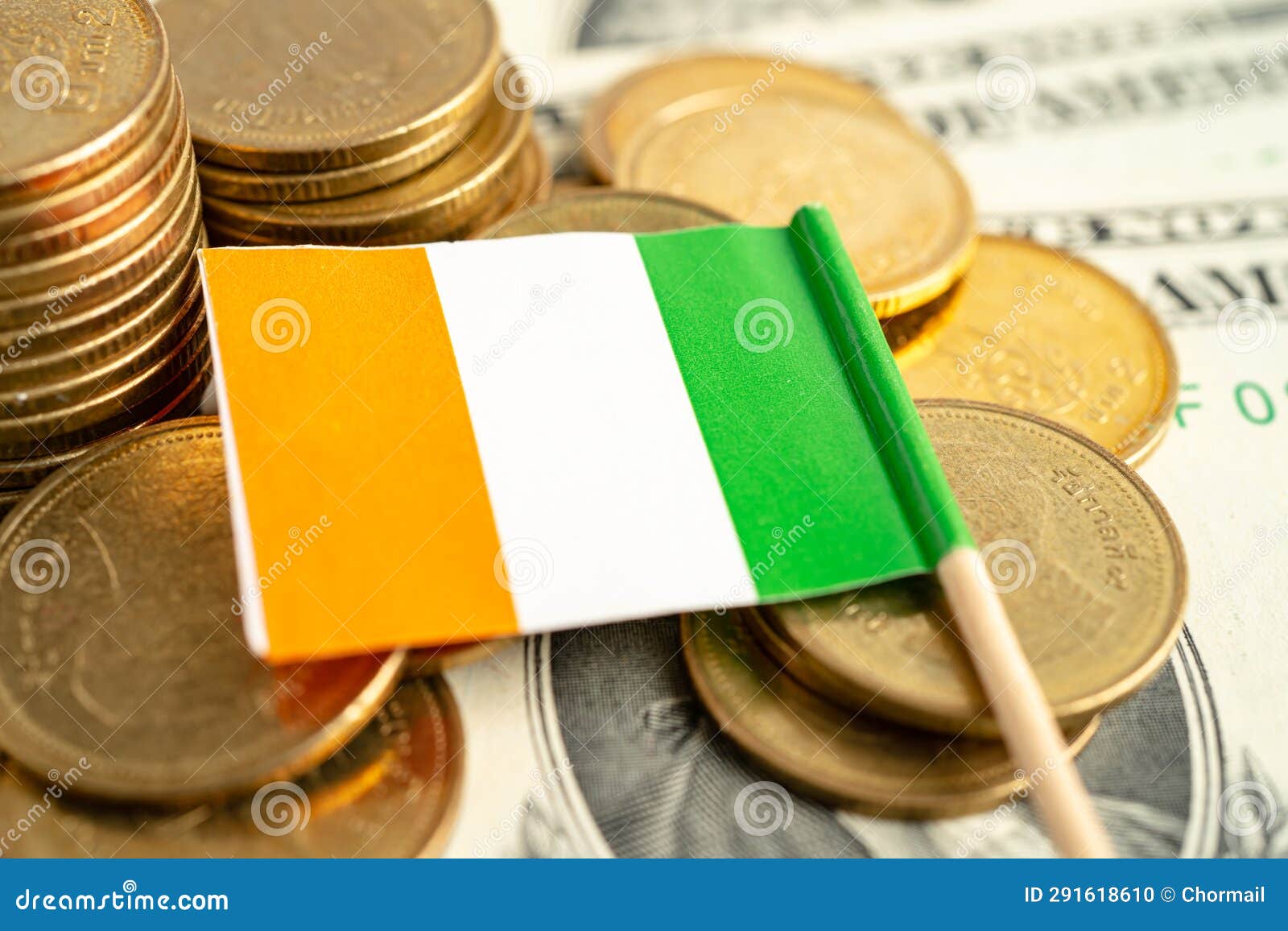 Stack of Coins with Ireland Flag and US Dollar Banknotes Stock Photo