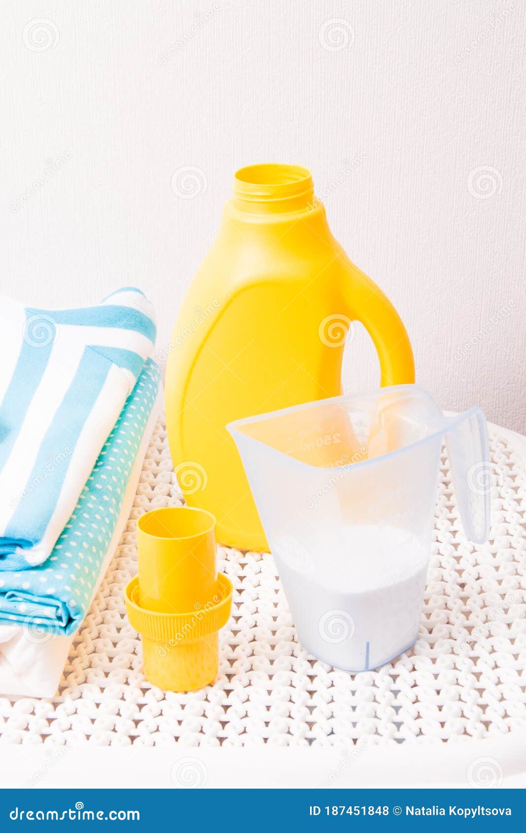 A Stack of Colored Laundry, Clothespins, Laundry Detergent in a