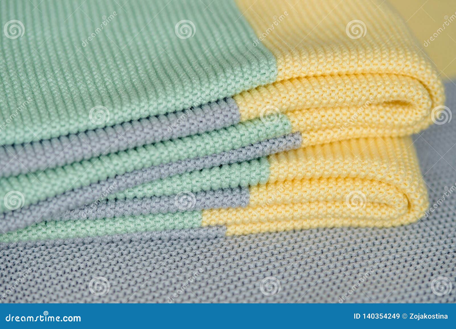 The Stack of Colored Striped Coverlets is on a Gray Background Stock