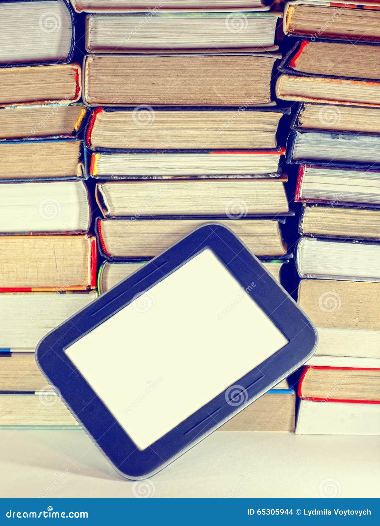 Stack of Colorful Books and Electronic Book Reader. Stock Photo Image