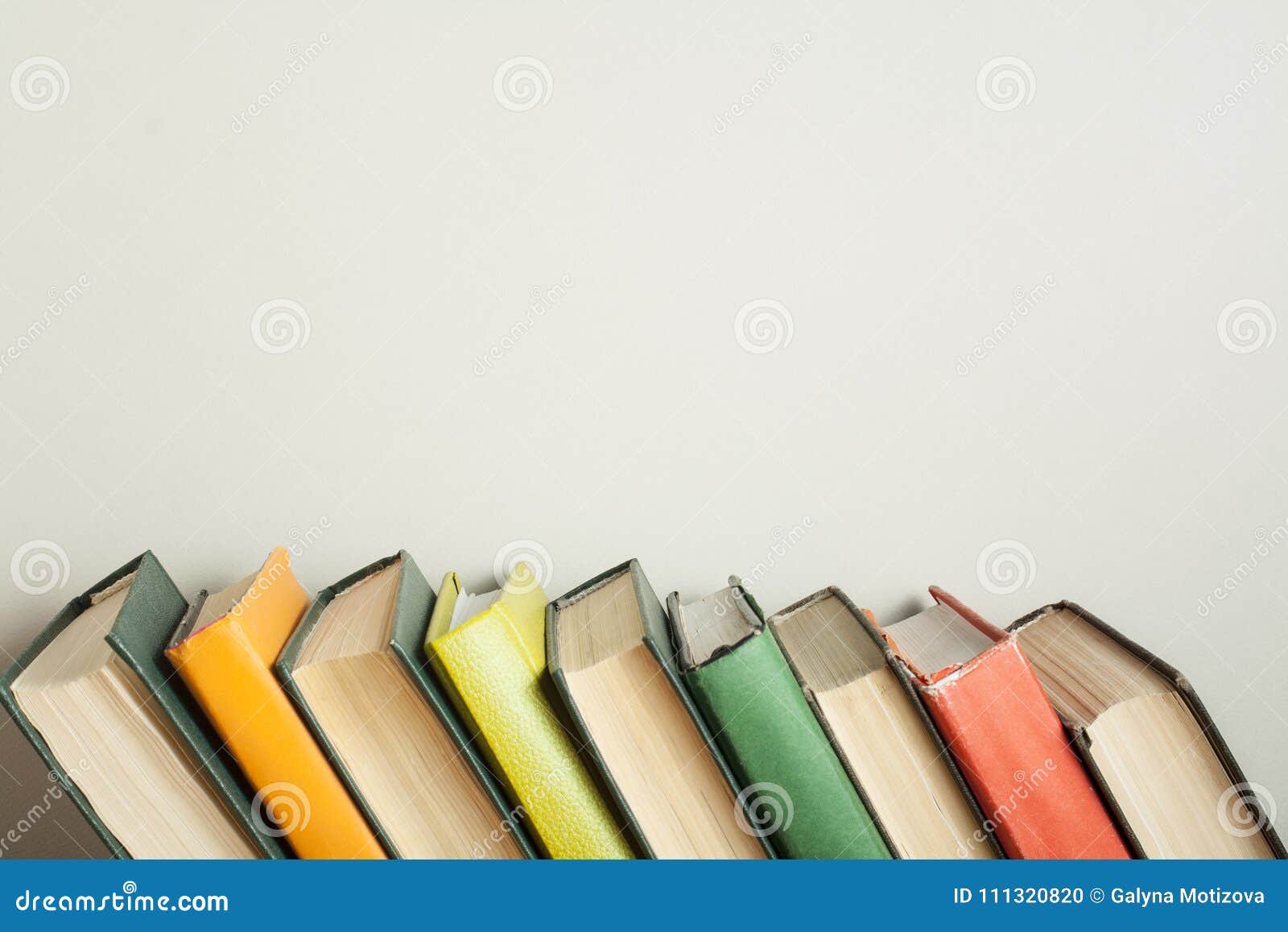 Stack Of Colorful Books On Wooden Desk Copy Space For Text Back