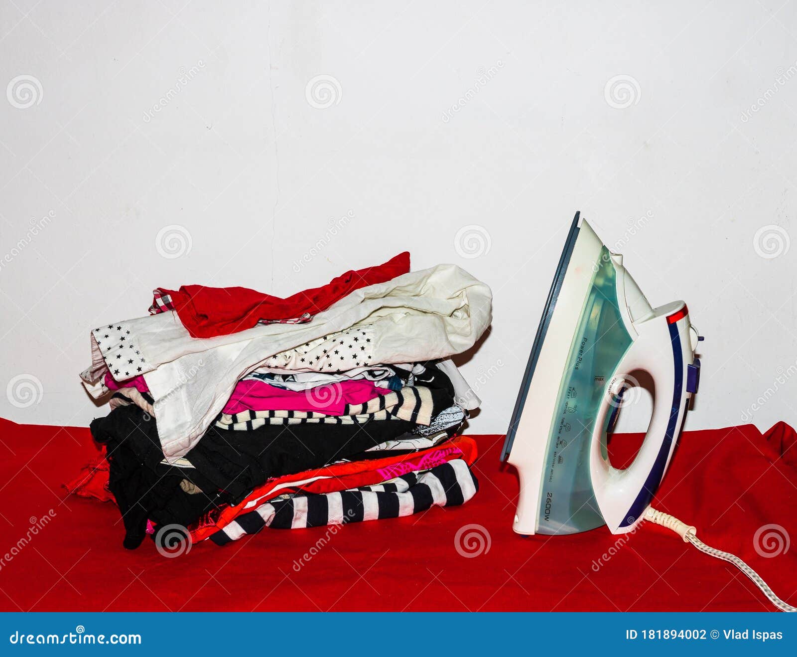 Stack of Colorful Cotton Clothes and Iron. Household Laundry Ironing ...