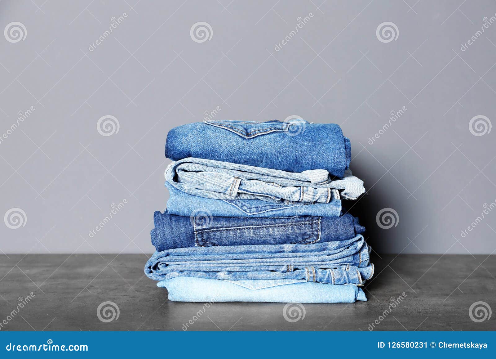 Stack of Different Jeans on Table Stock Image - Image of size ...