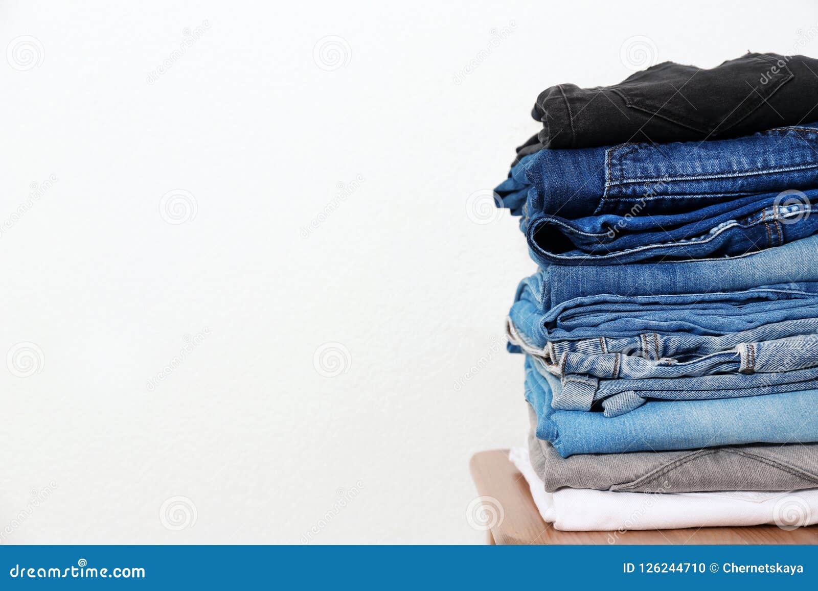 Stack of Different Jeans on Table Stock Photo - Image of denim, clean ...