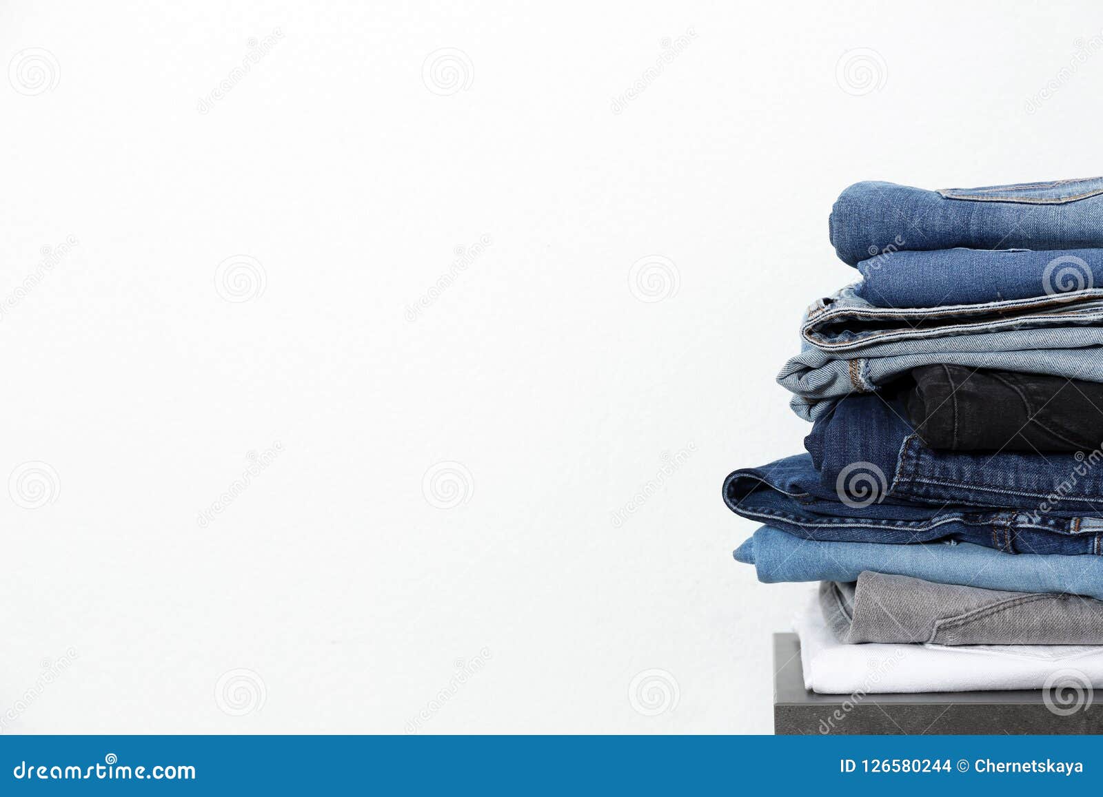 Stack of Different Jeans on Table Stock Photo - Image of modern, shop ...