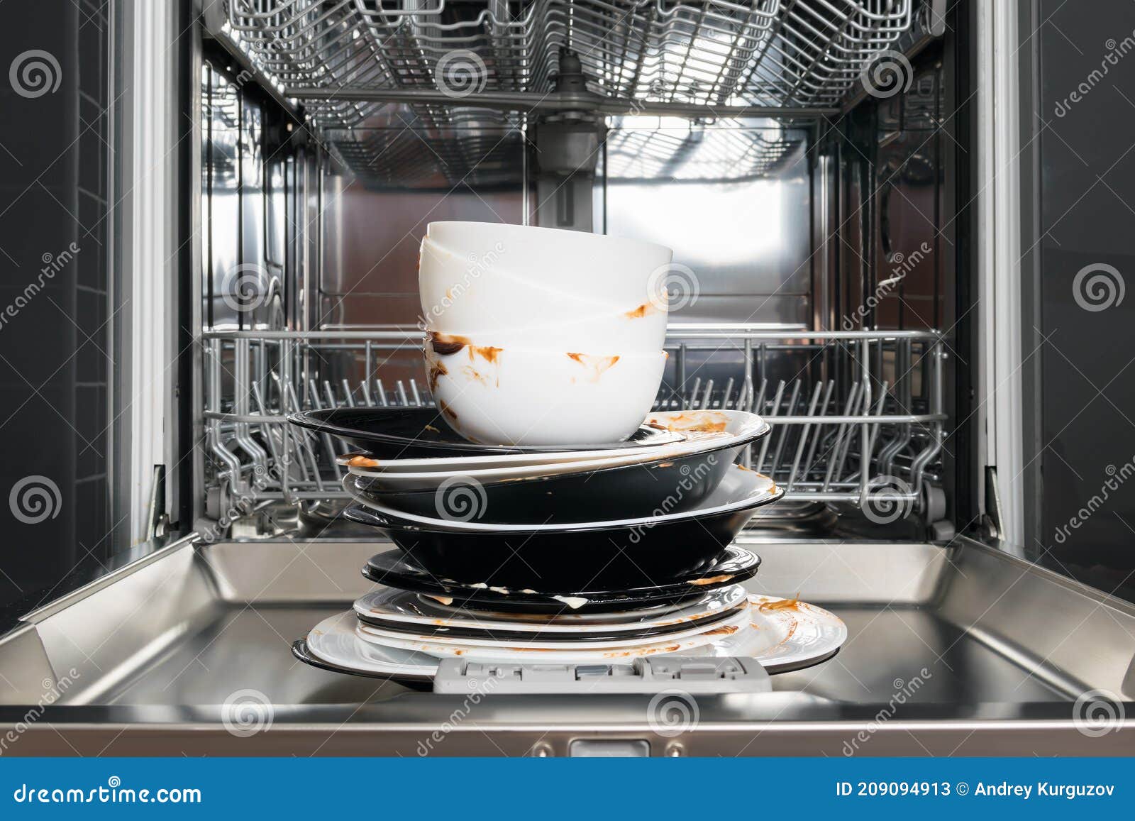 A Stack of Dirty Dishes is on the Door of the Dishwasher Stock Image
