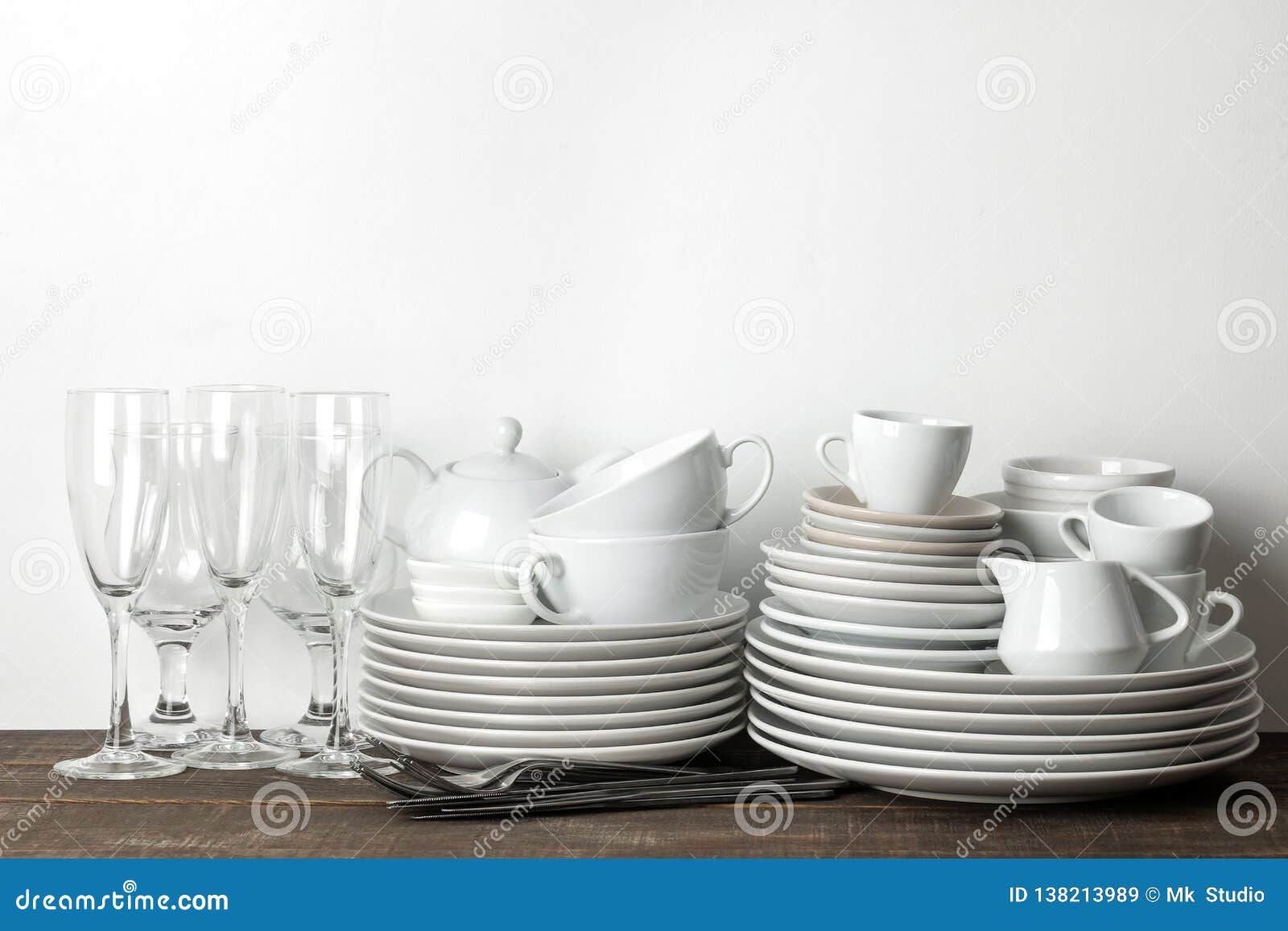 A Stack of Dishes. Tableware on a Brown Wooden Table. Dishes for