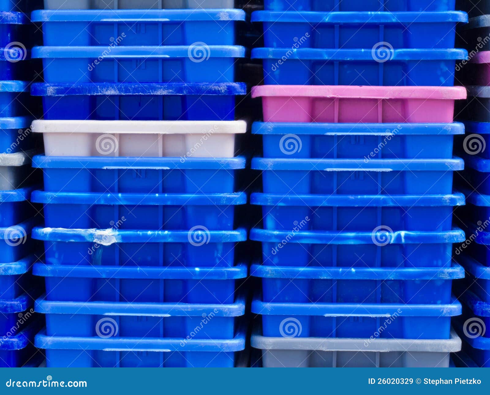 stack of empty colorful plastic fishery containers