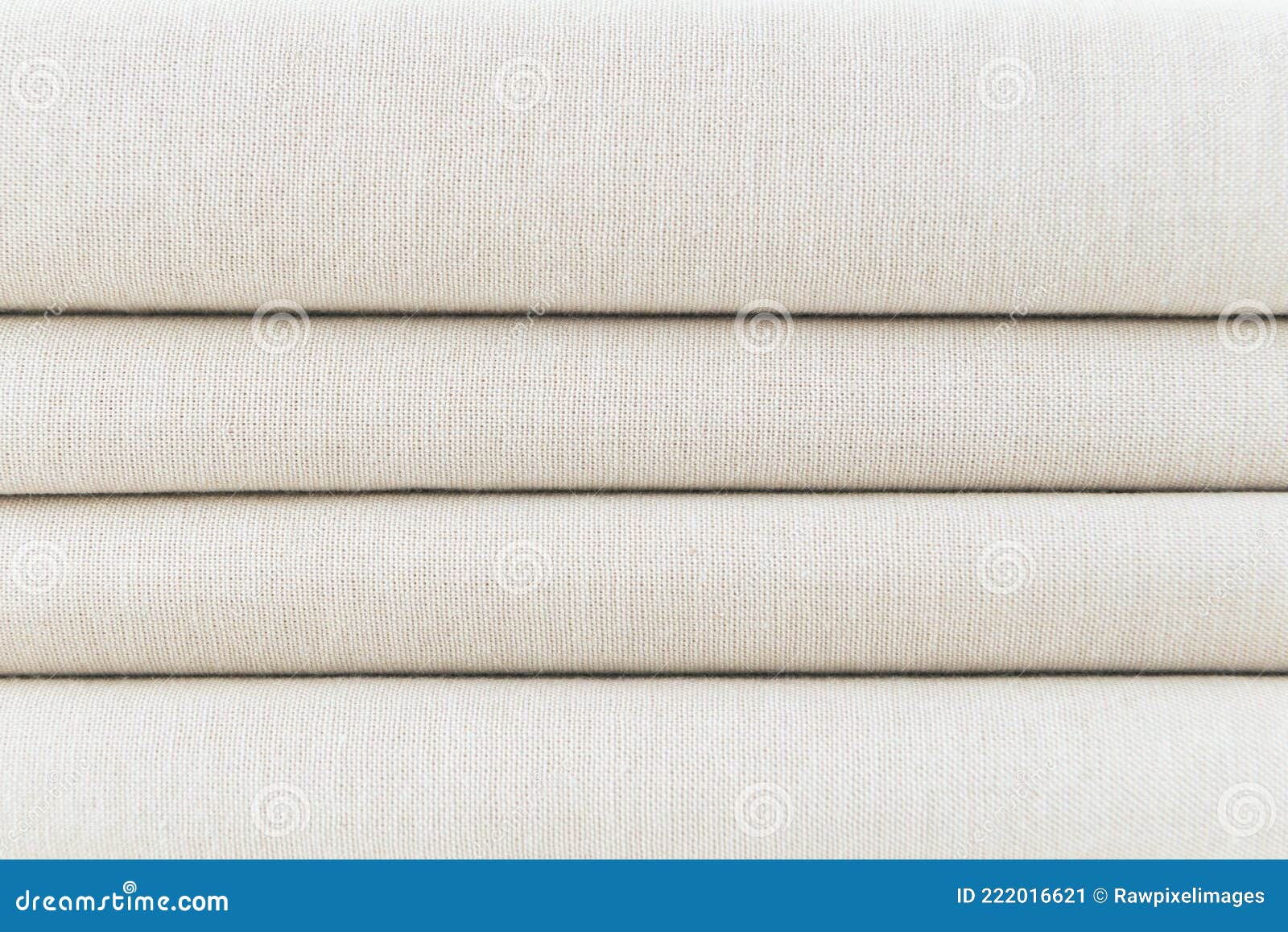 stack of folded beige woven fabric patterned background