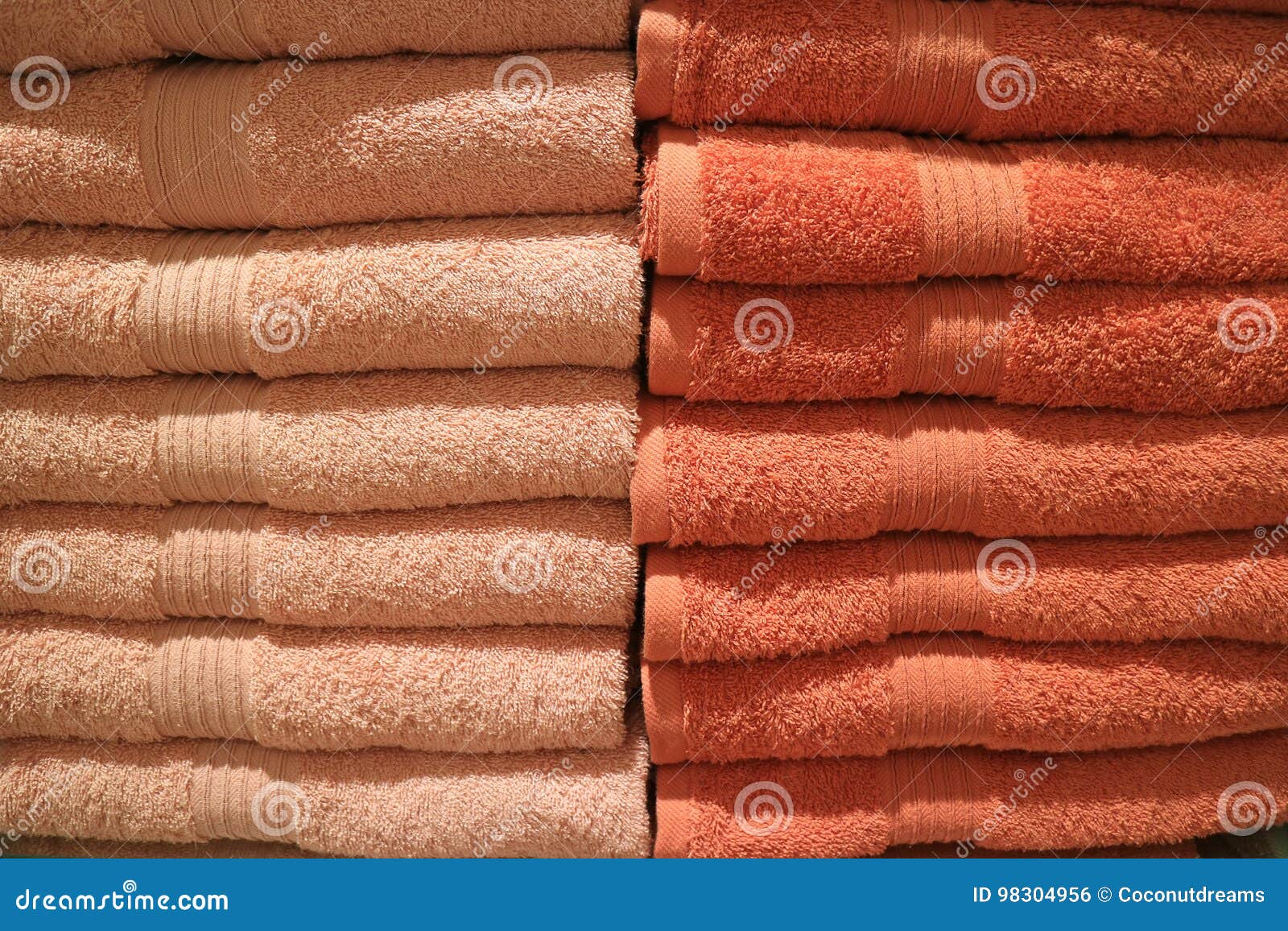 Stack of Folded Many Tones of Orange Color Bath Towels Stock Photo