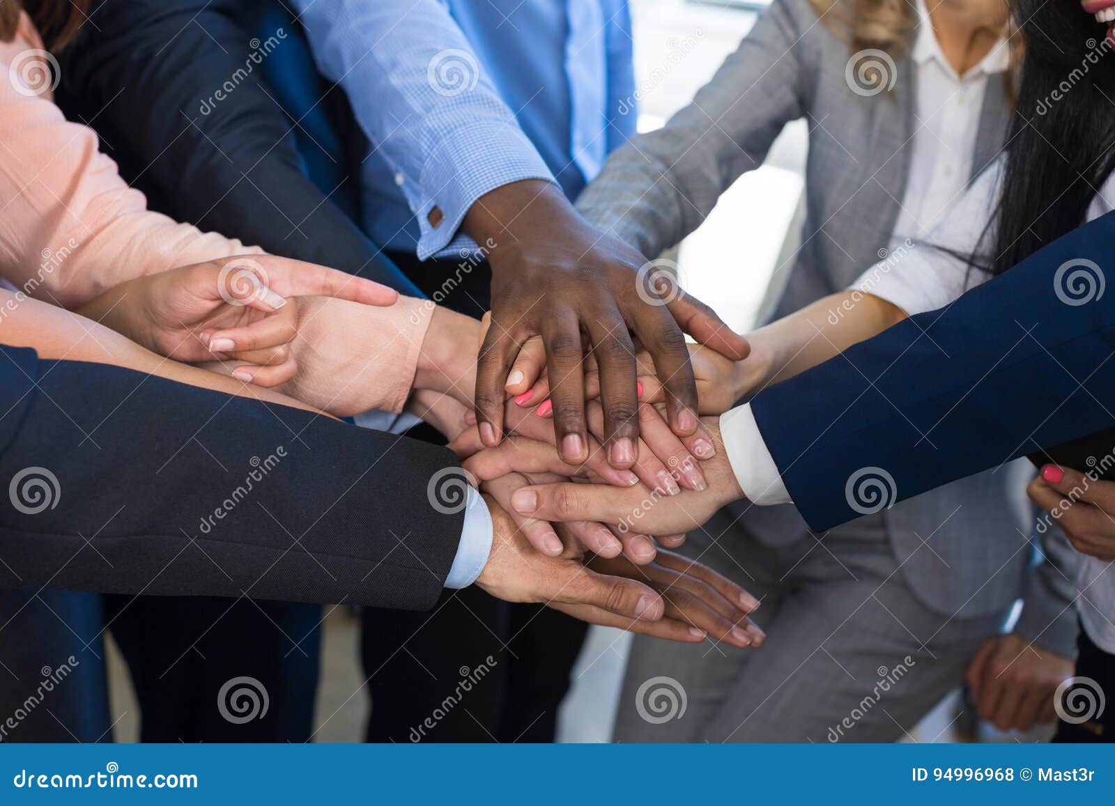 stack of hands, teamwork concept, business people group joining arms in pile, diverse team of businesspeople working