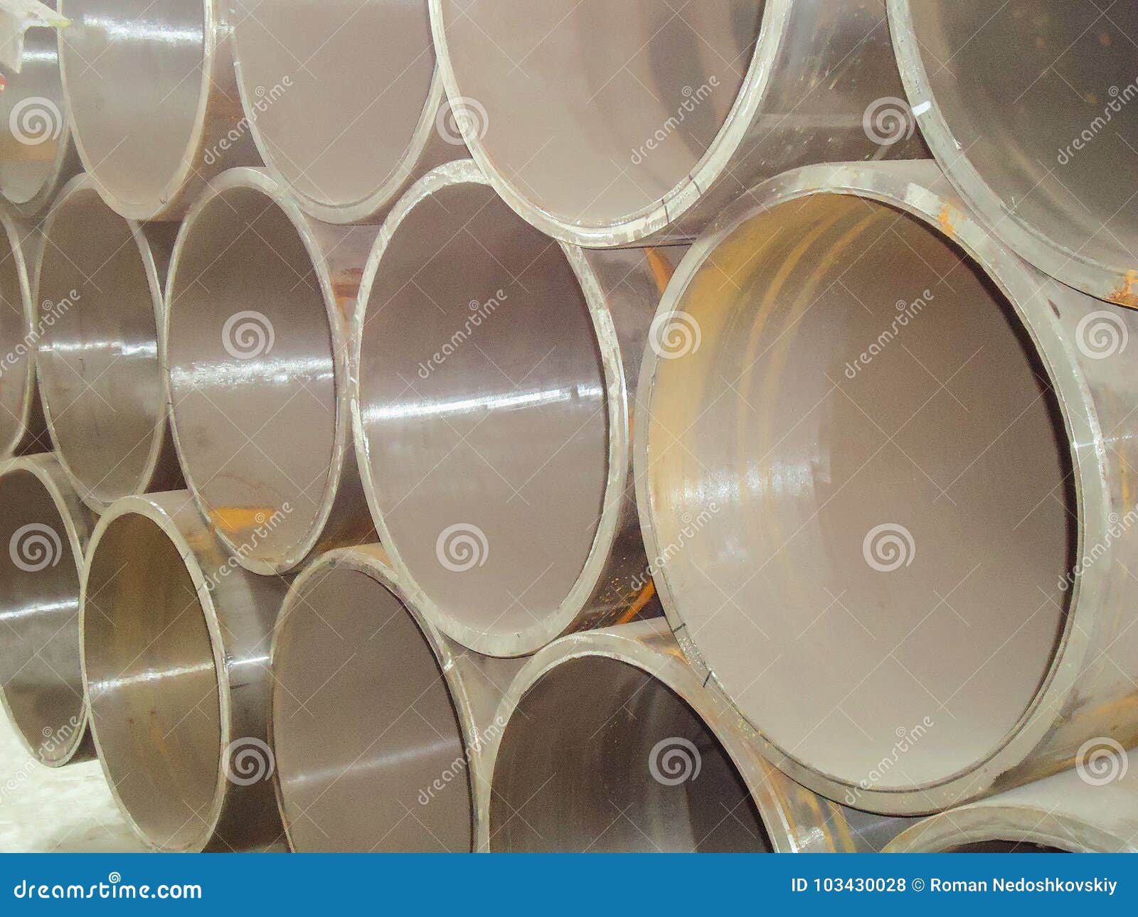 Stack of Large Diameter Steel Pipes in an Industrial Warehouse