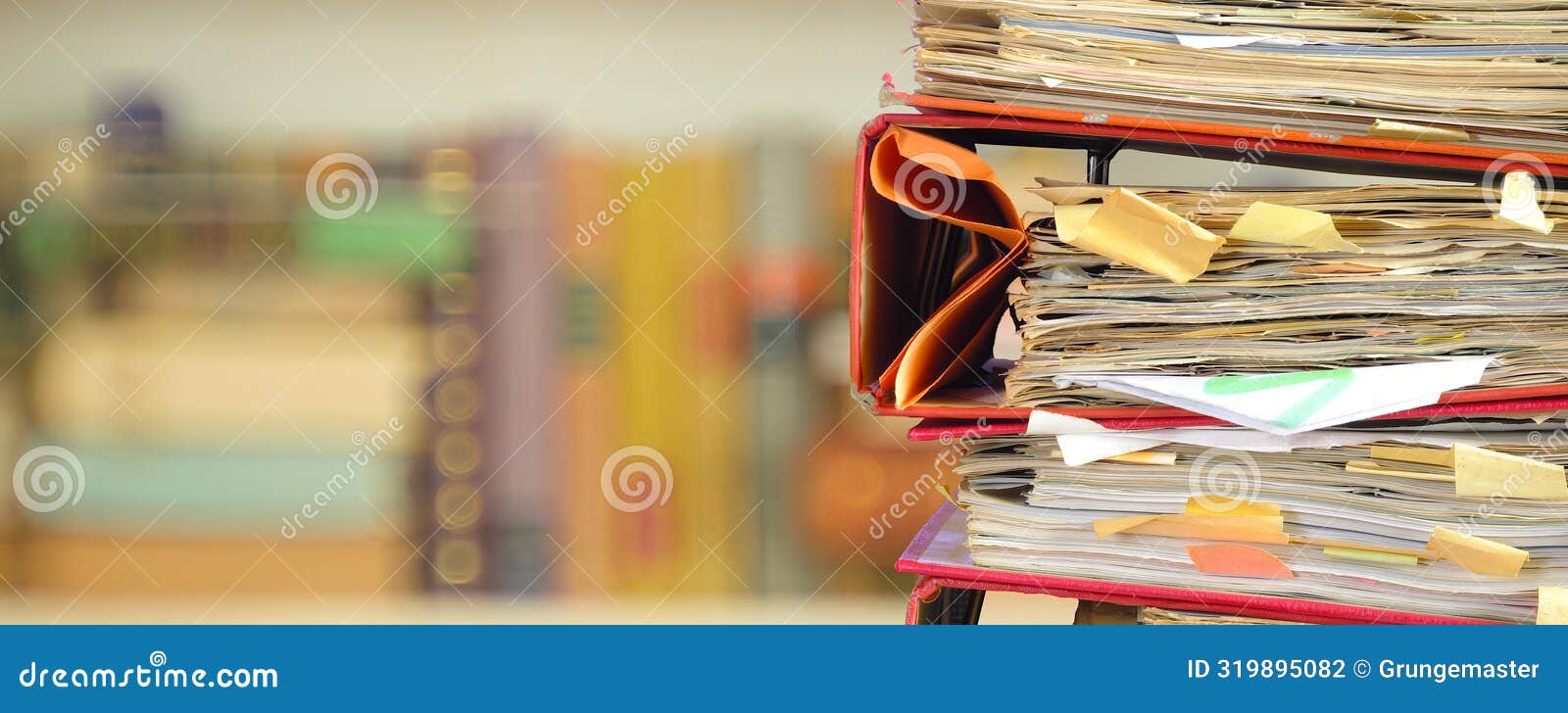 stack of messy file folders with narrow depth of field, blurred bookshelf in the back,red tape, bureaucracy,aministration,